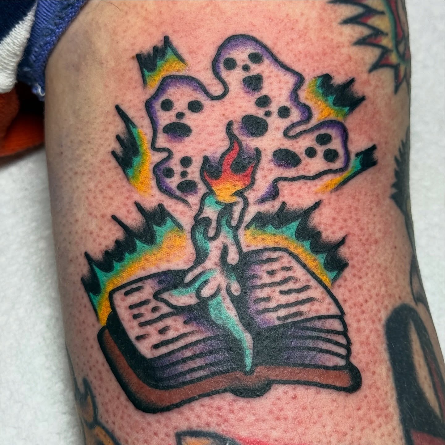 Open book with ghostly figures new school tattoo on the forearm by ๐ฎ๐๐๐๐ ๐ญ๐๐๐๐๐