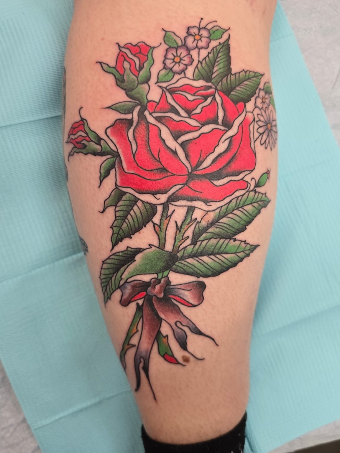 Red rose bouquet American traditional tattoo on the forearm by Columbus tattoo artist