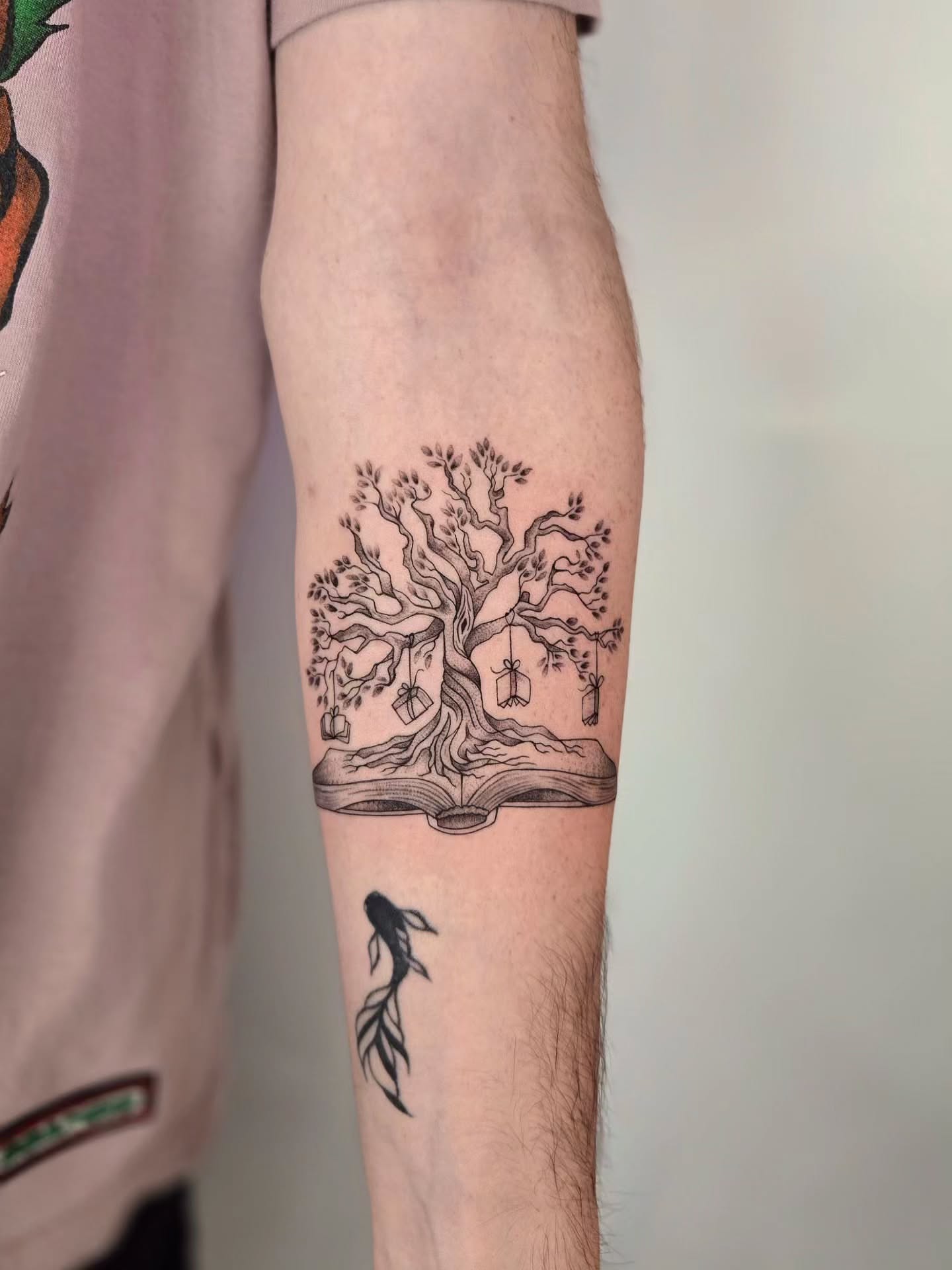 Book with tree black and grey tattoo on the forearm by Kirstie Lew Tattoo