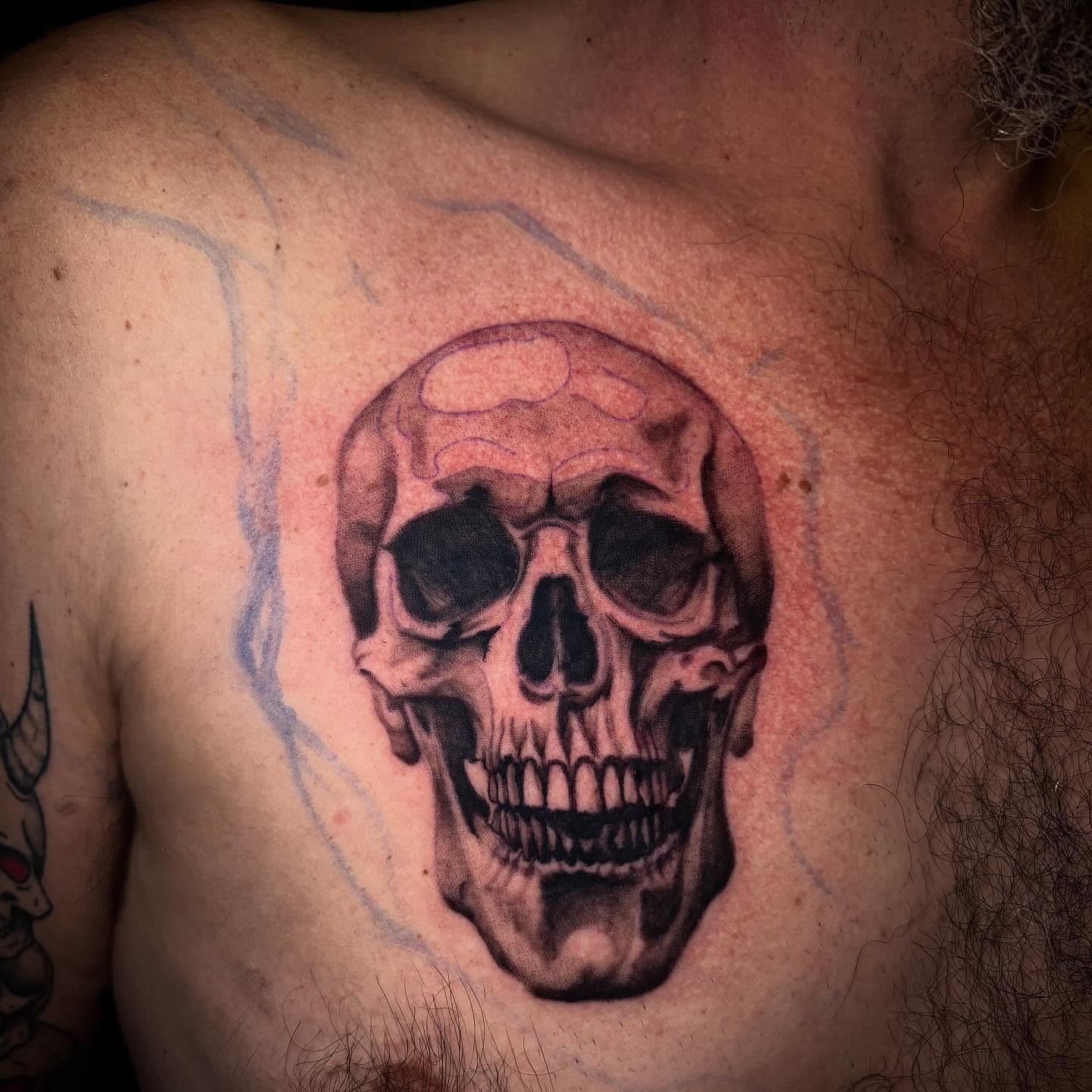 Skull realism tattoo on the chest by Haley Byers