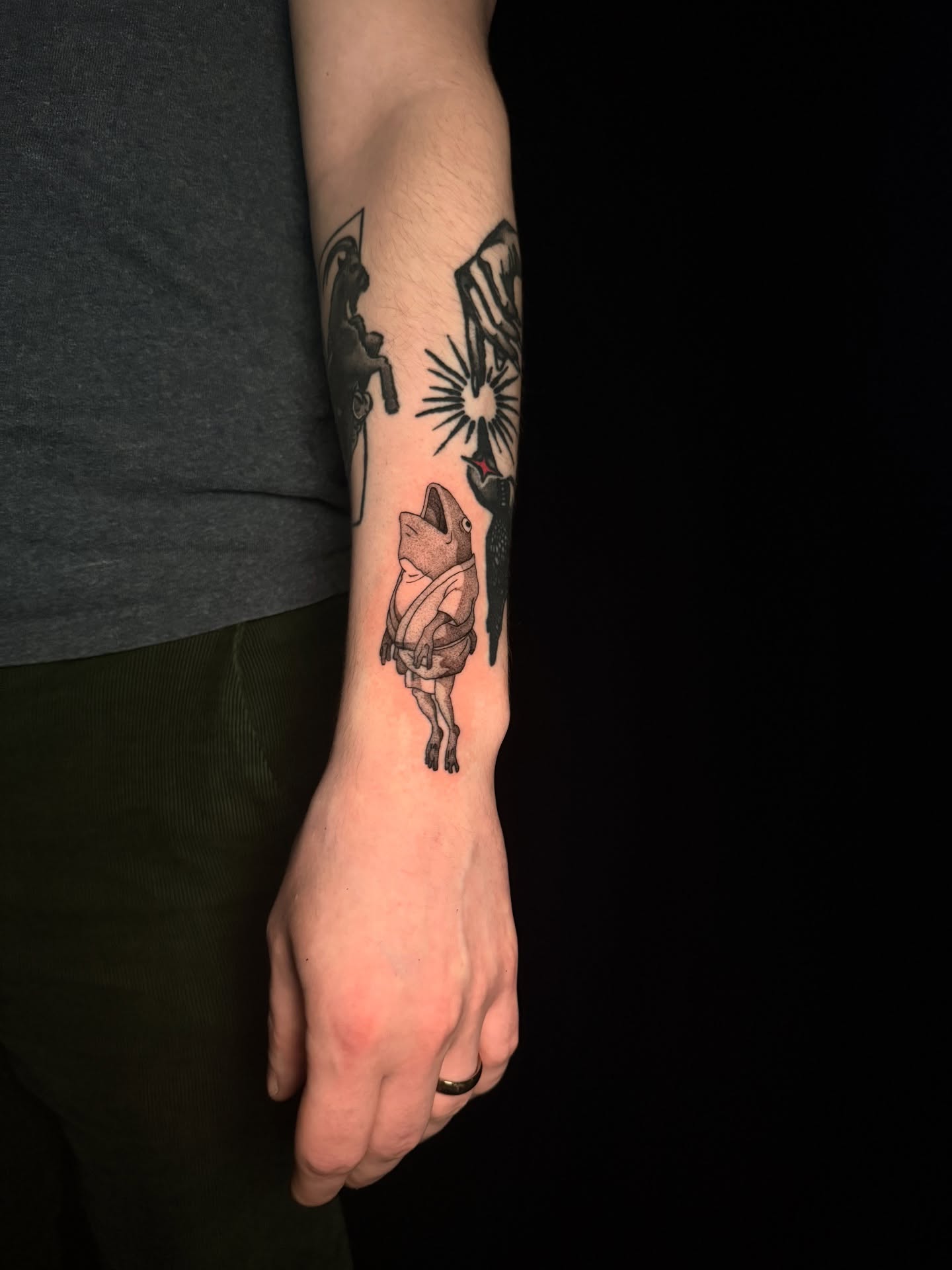 Frog black and grey tattoo on the forearm by z o y a, Seattle, Washington