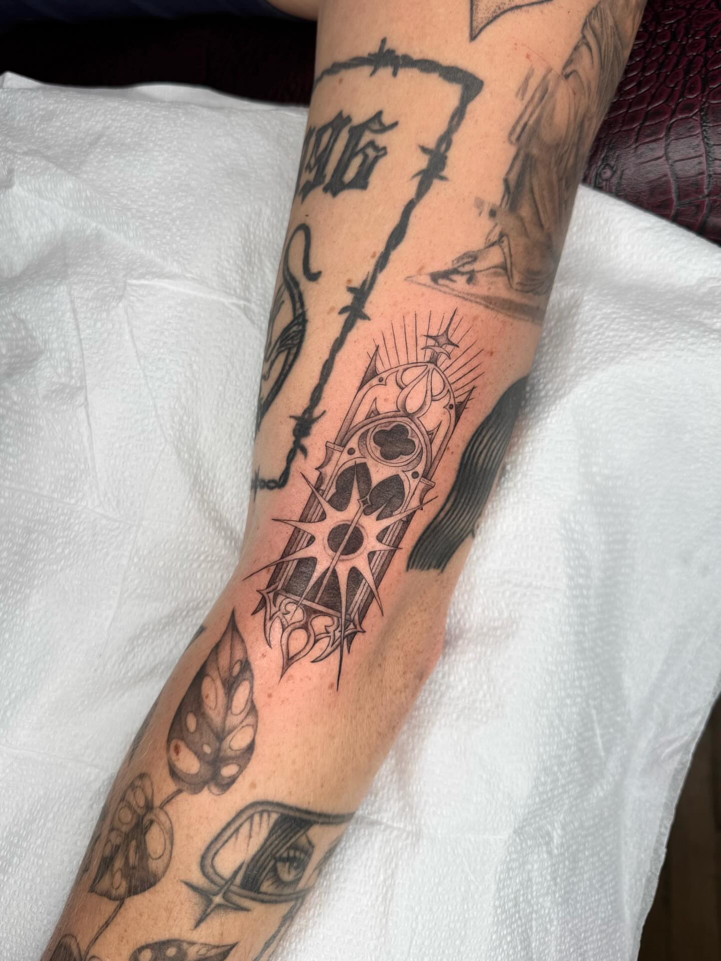 Abstract design black and grey tattoo on the forearm by Maddie Hammell