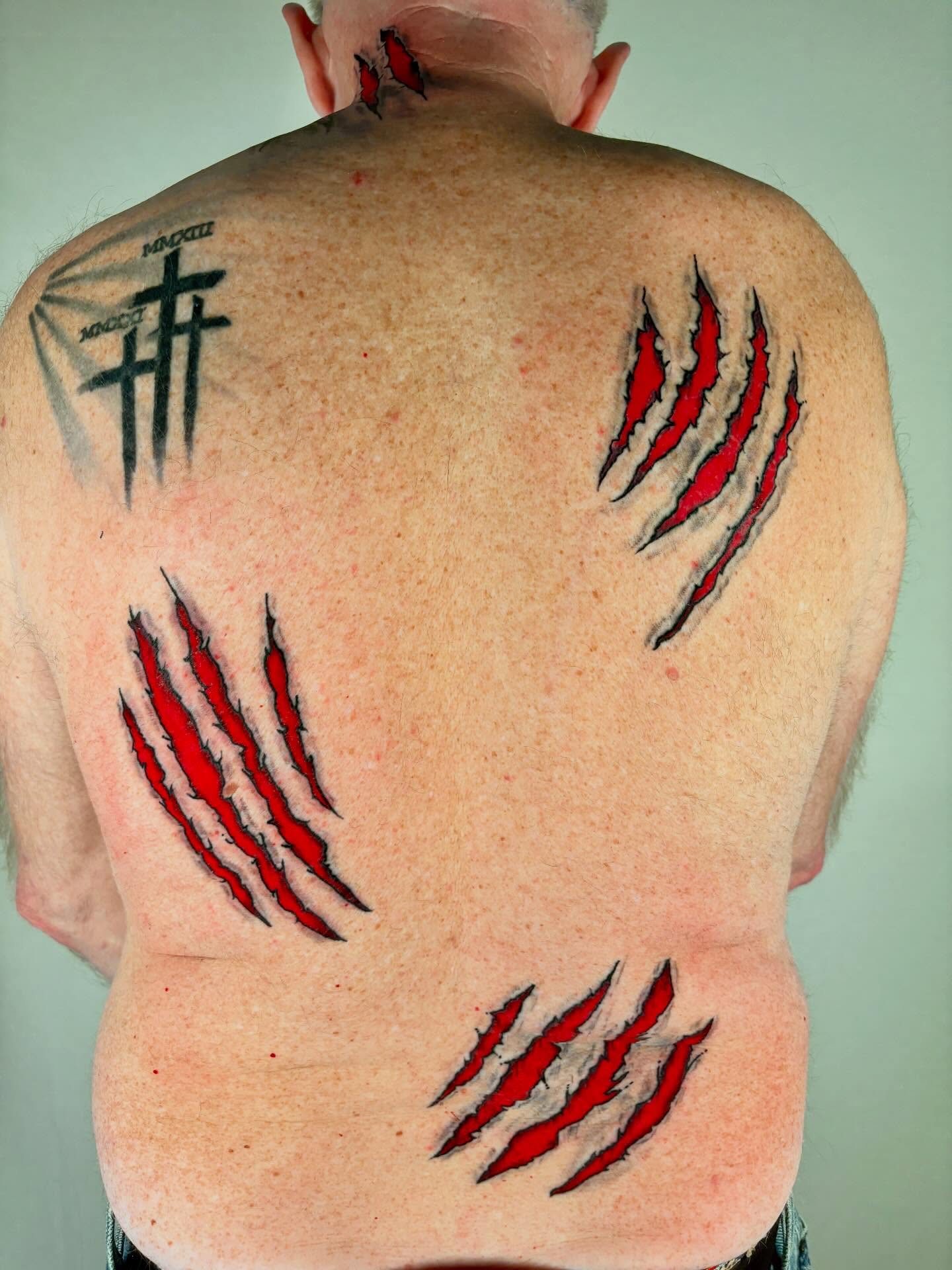 Claw marks black and grey tattoo on the back by Davie Tattoos