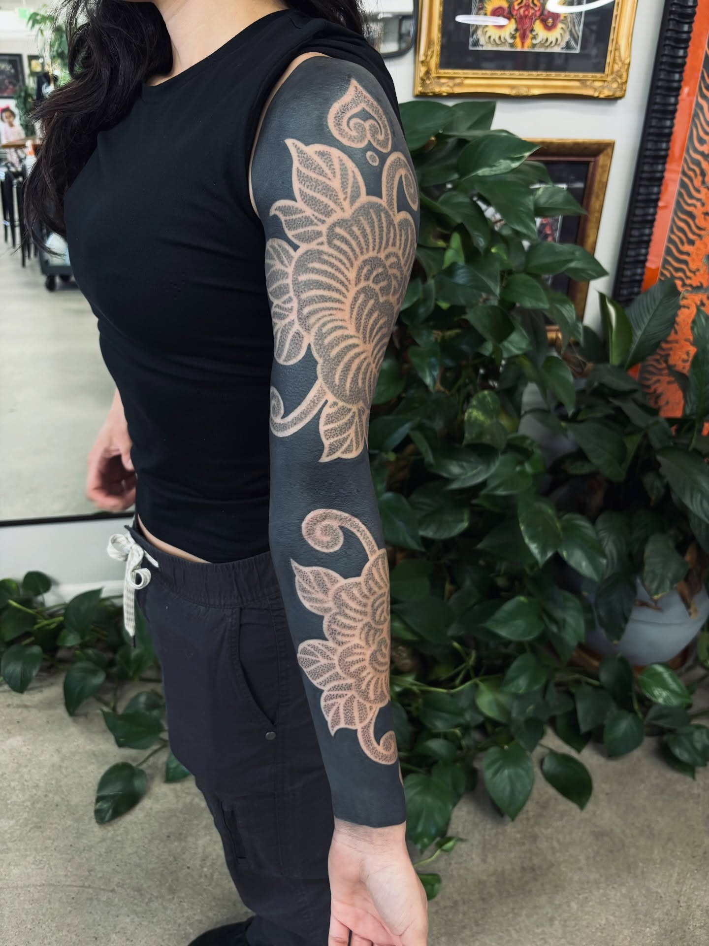 Floral pattern dotwork tattoo on the upper arm by Kolbi Alexis