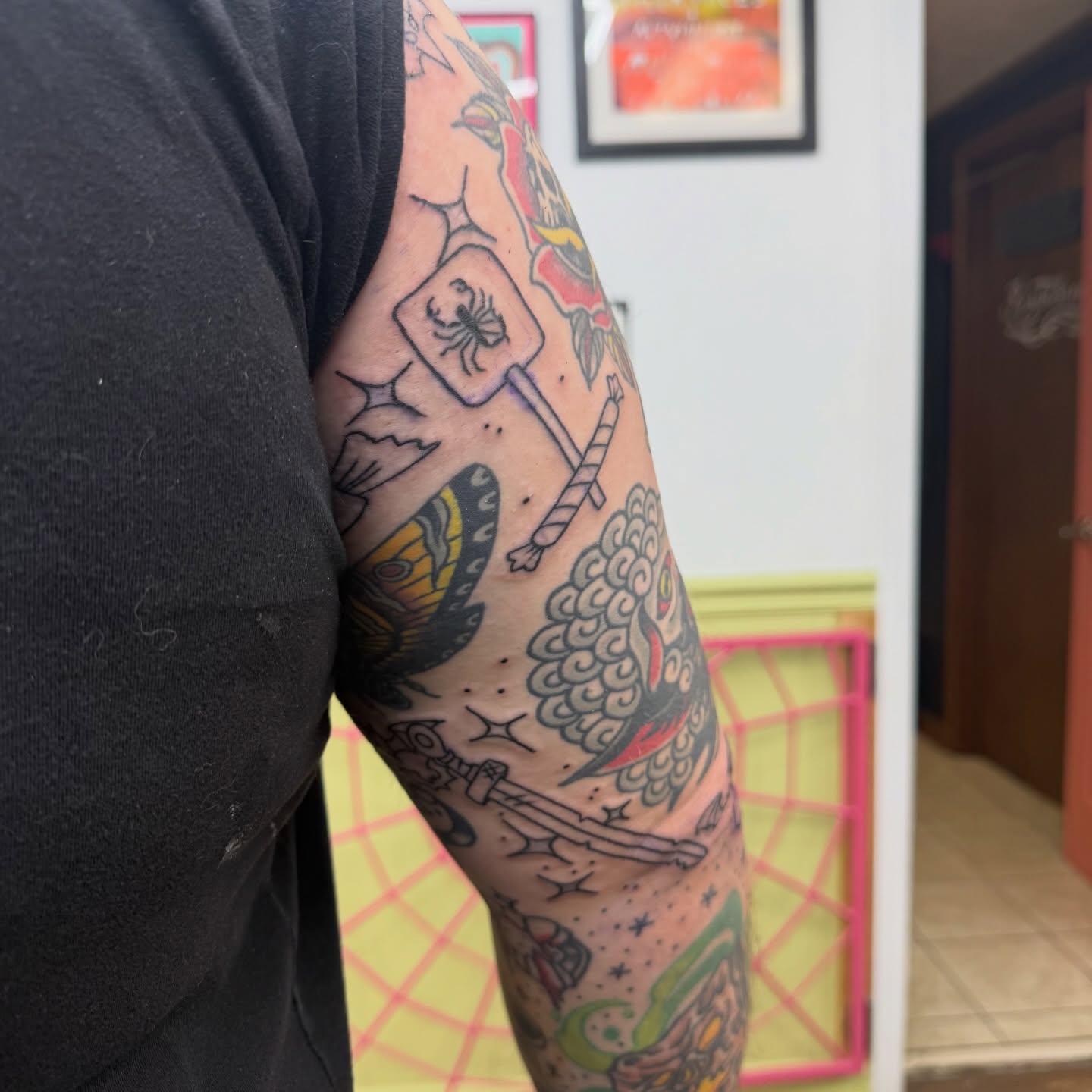 Marshmallow and butterfly American traditional tattoo on the forearm by autumn sky