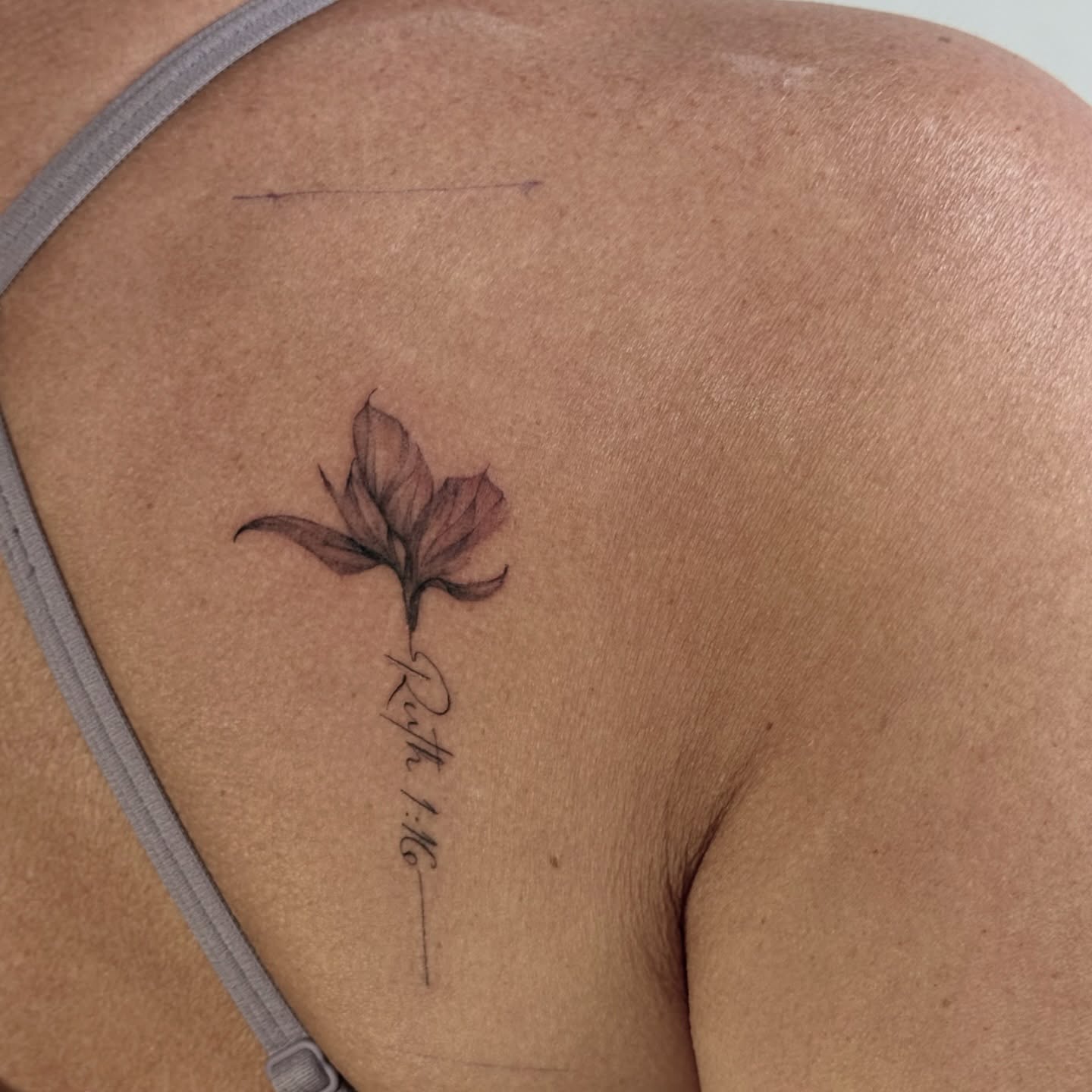 Flower black and grey tattoo on the shoulder by autumn sky
