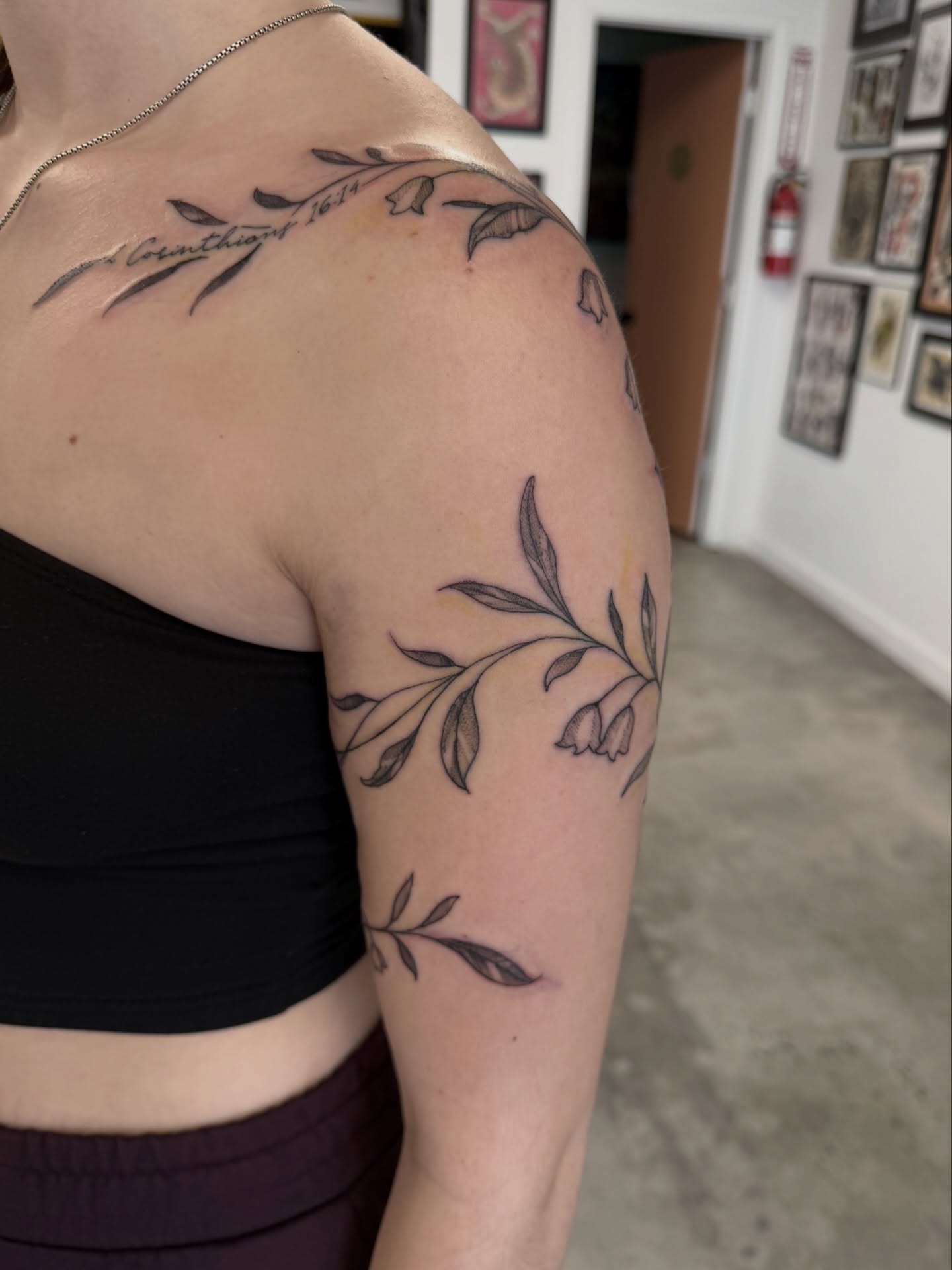 Branch with leaves black and grey tattoo on the shoulder by Christopher Layman