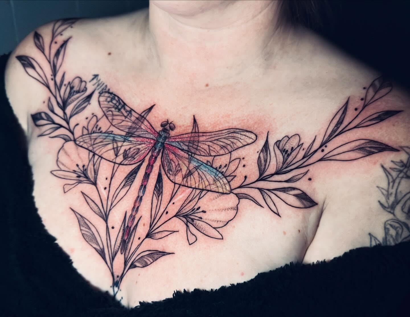 Dragonfly and floral dotwork tattoo on the chest by Tasha