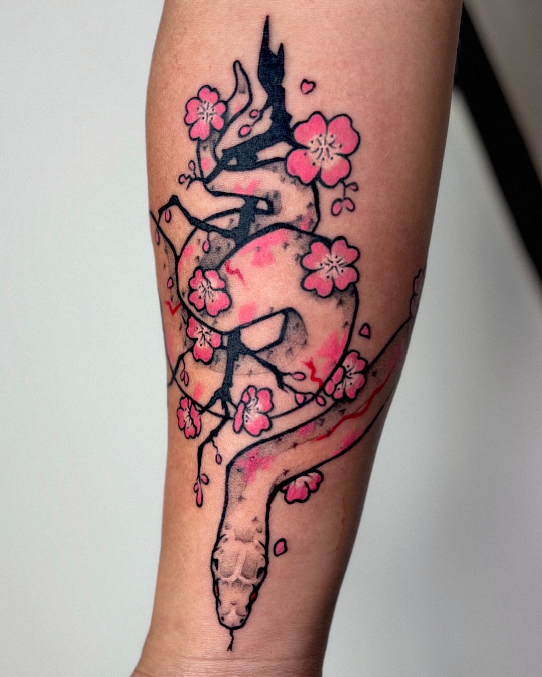 Heart with cherry blossoms watercolor tattoo on the forearm by Kal