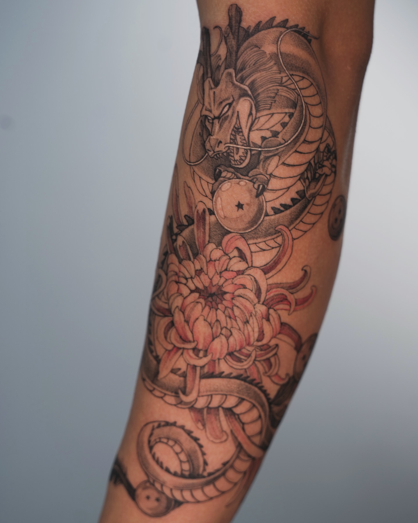 Dragon and chrysanthemum japanese irezumi tattoo on the forearm by Tri