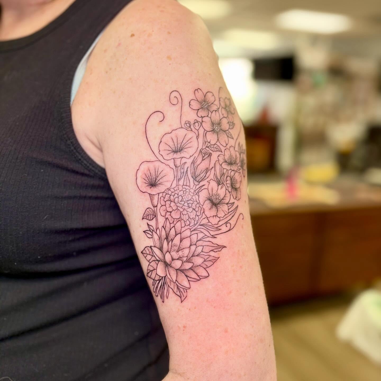 Floral bouquet black and grey tattoo on the forearm by bradyn thornton: eco-tattoo artist