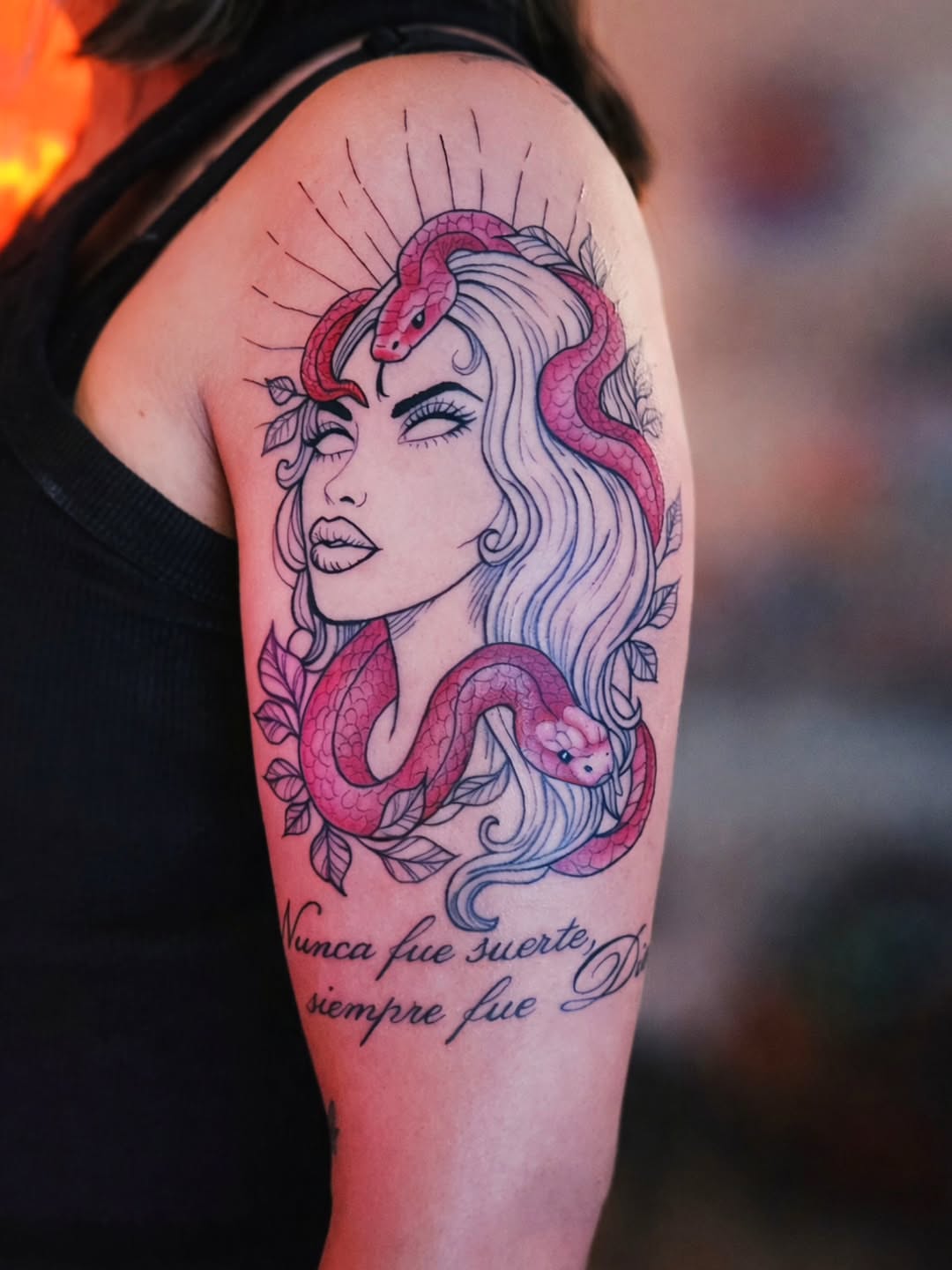 Woman with snake illustrative tattoo on the upper arm by Luke Jordan Ink, Louisville, Colorado