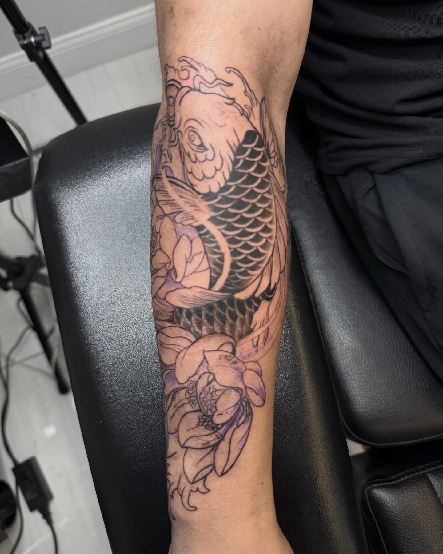 Koi fish and lotus flower japanese irezumi tattoo on the forearm by Kai, Charlotte, North Carolina