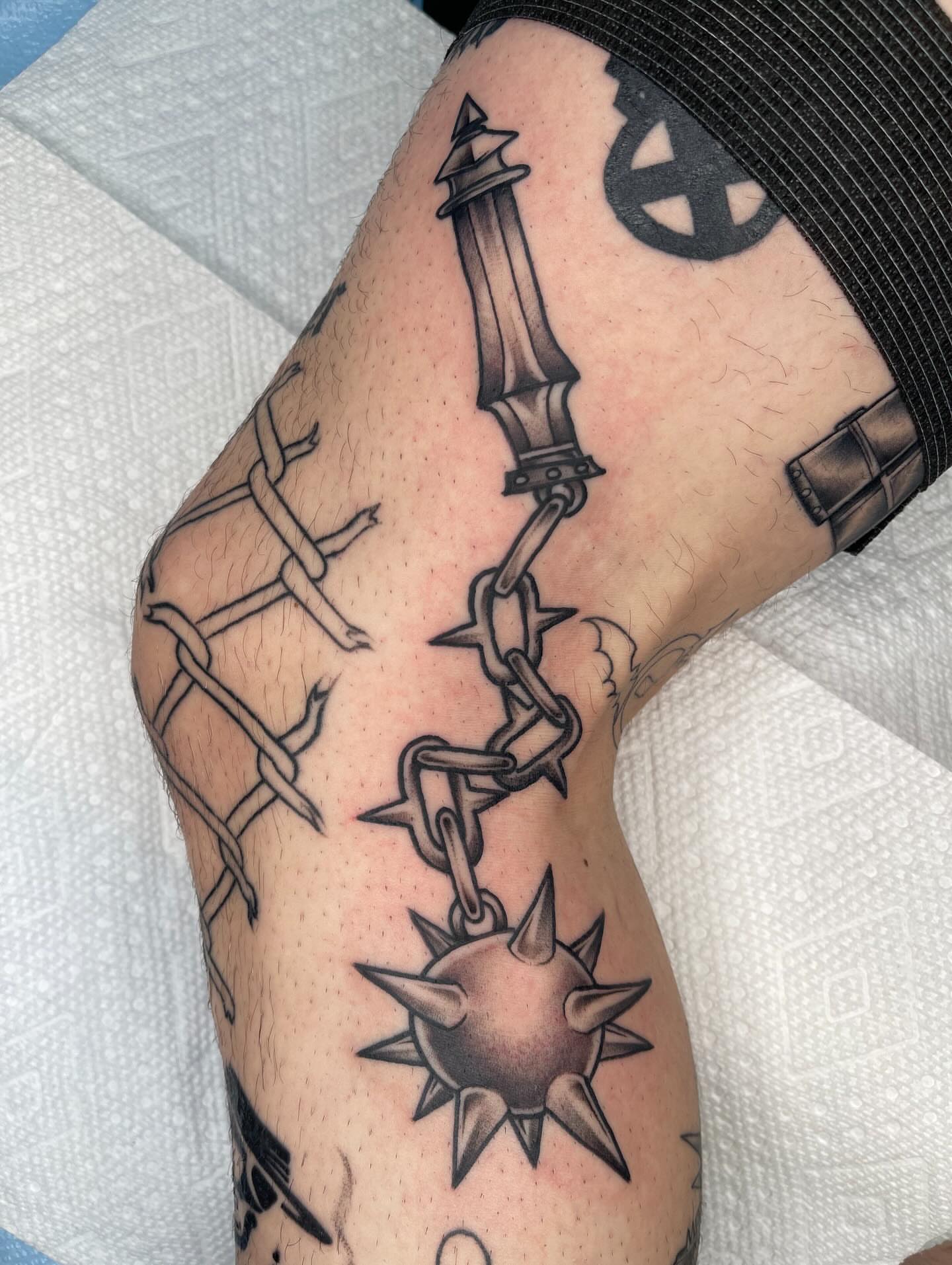 Barbed wire and spiked ball black and grey tattoo on the forearm by Allison Gallagher