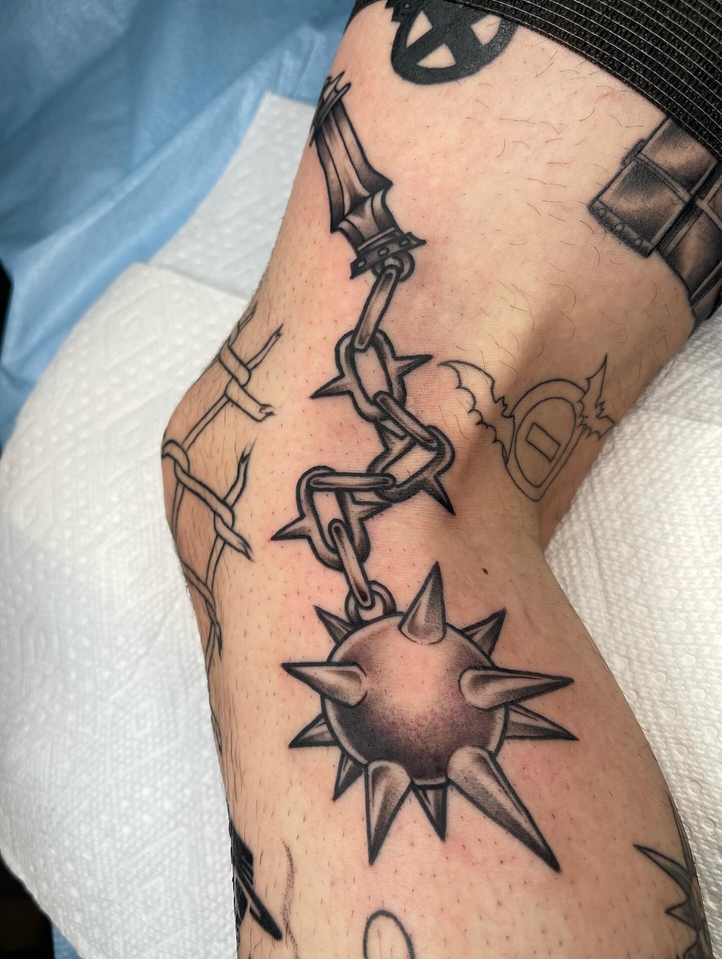 Barbed wire and spiked ball black and grey tattoo on the forearm by Allison Gallagher
