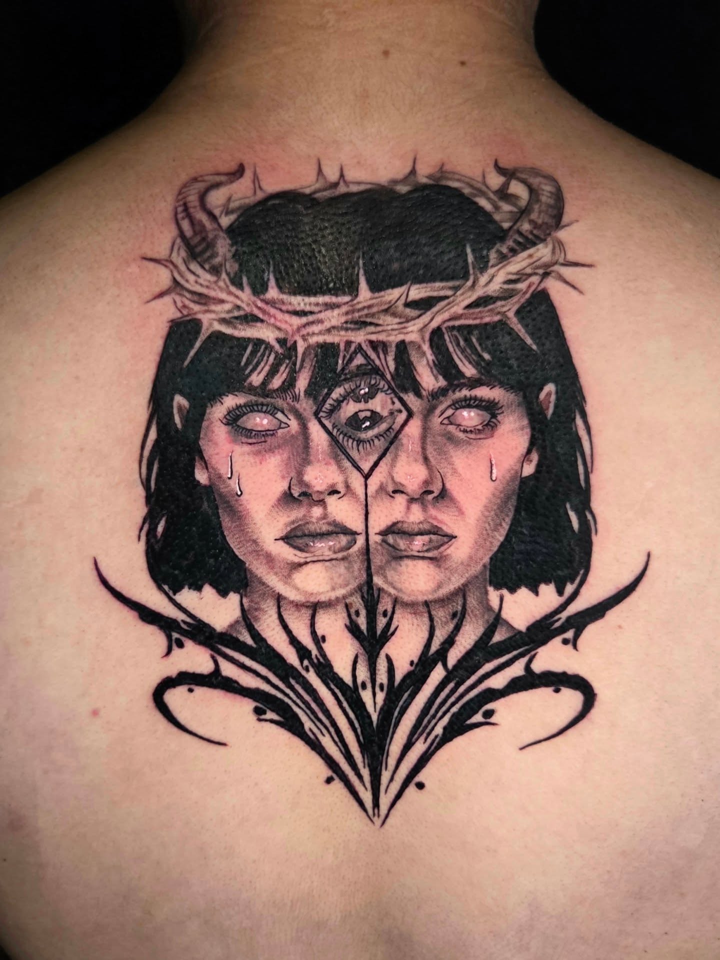 Crying faces realism tattoo on the back by Maya Neideck