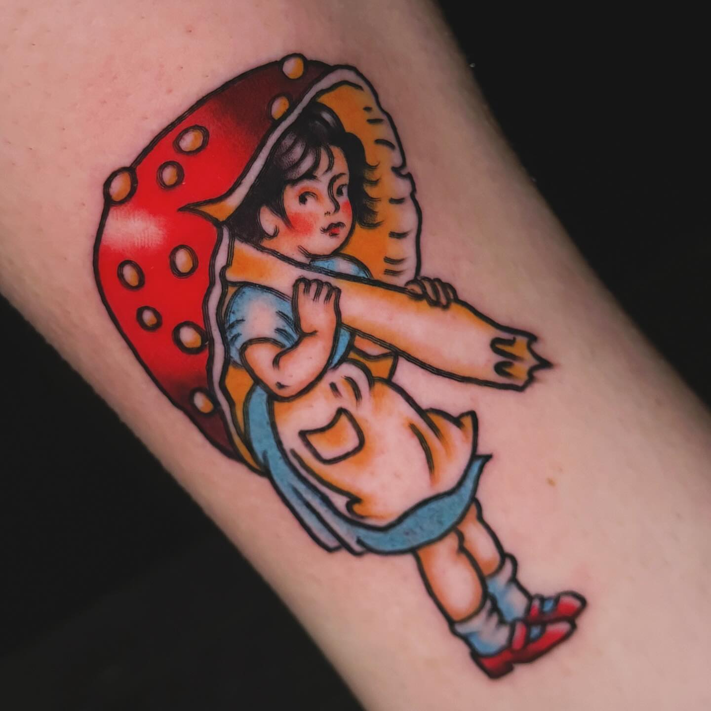 Child with umbrella American traditional tattoo on the forearm by Nikki Bee
