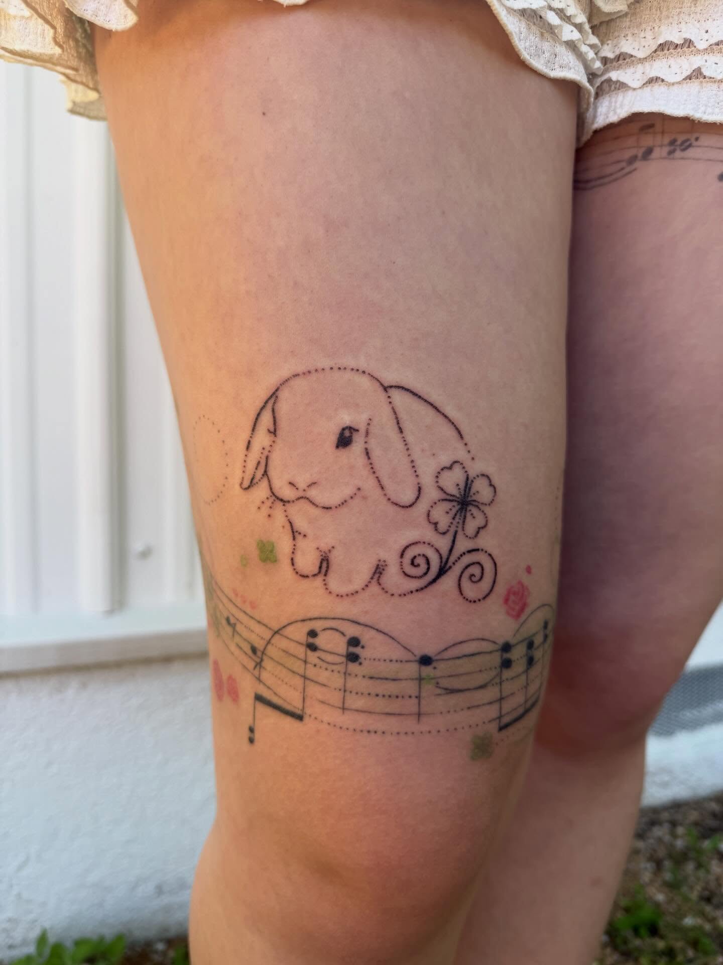 Rabbit and music notes dotwork tattoo on the thigh by springgreens