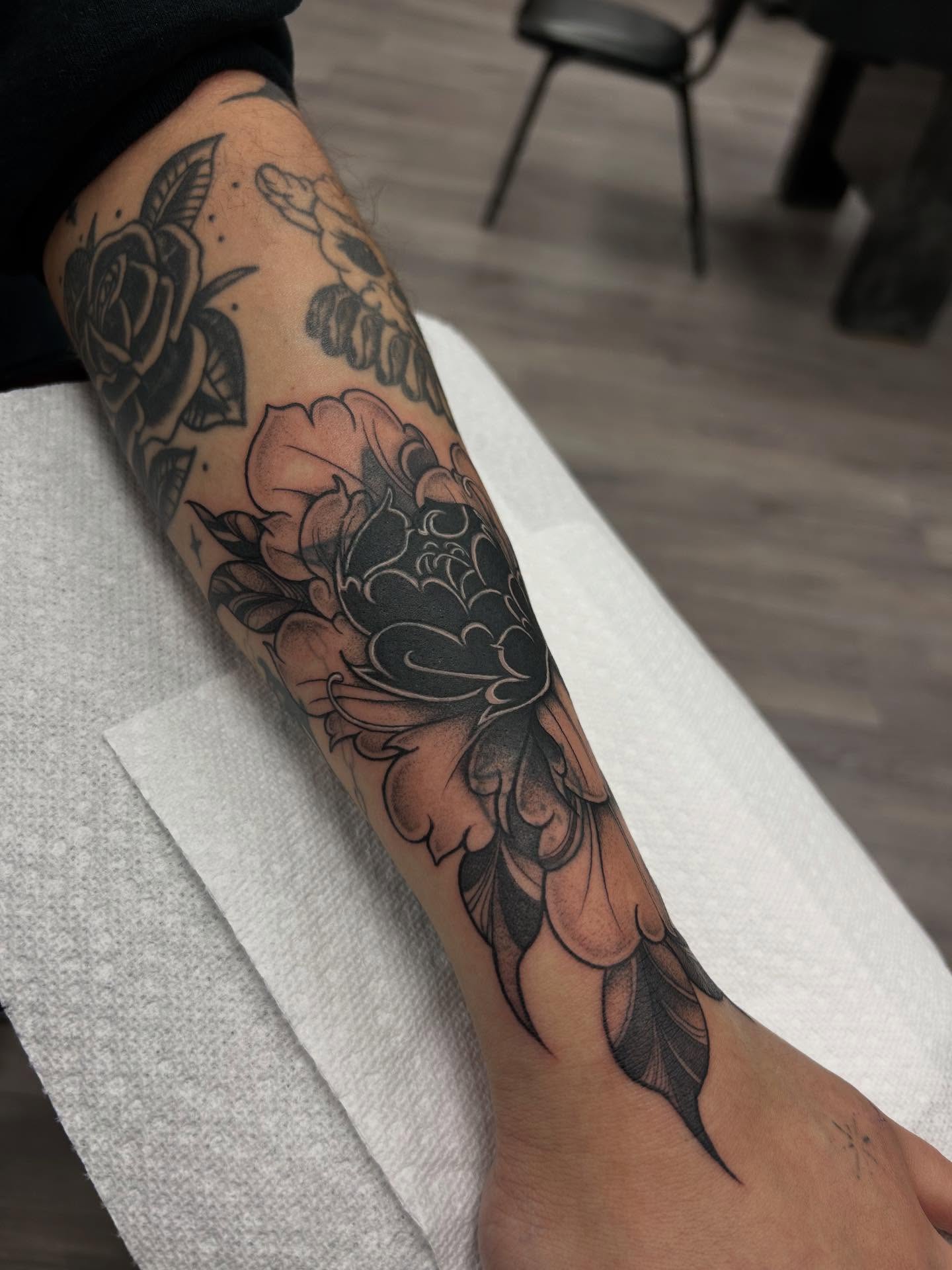 Peony American traditional tattoo on the forearm by Livy baby