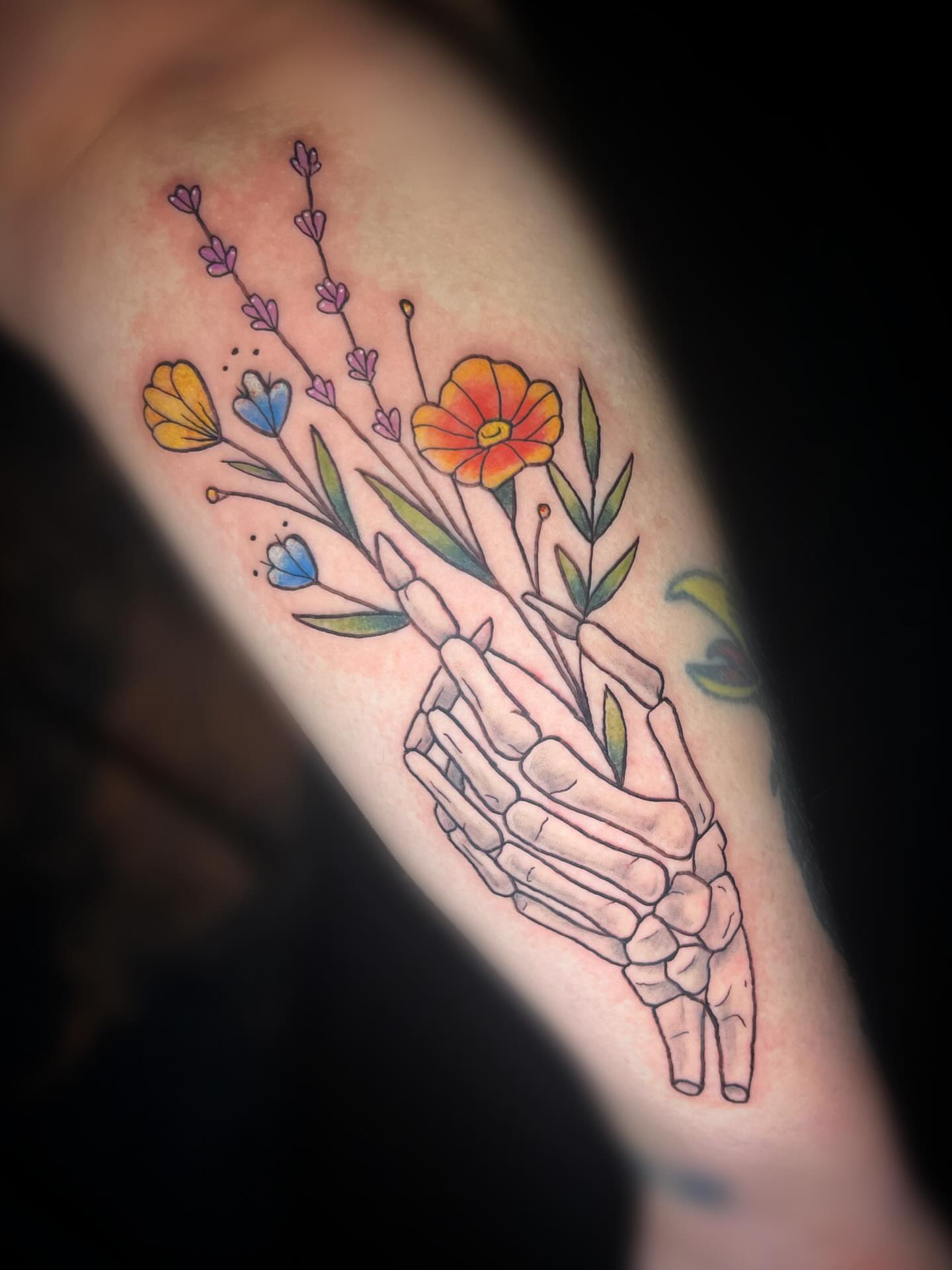Skeleton hands with flowers dotwork tattoo on the forearm by Saint