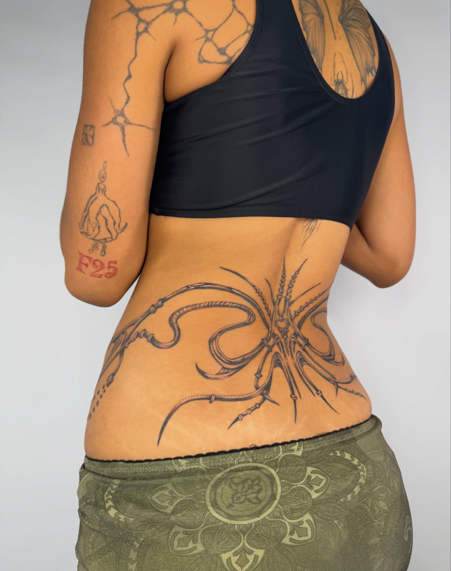 Octopus black and grey tattoo on the back by Lauren ๐