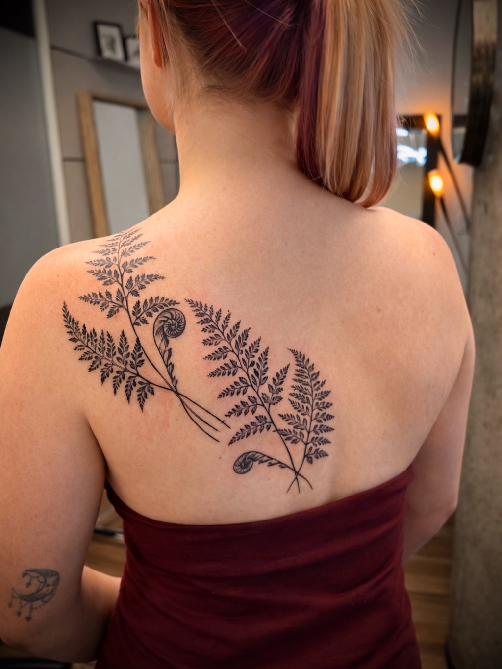 Fern black and grey tattoo on the back by Aristova Anastasia