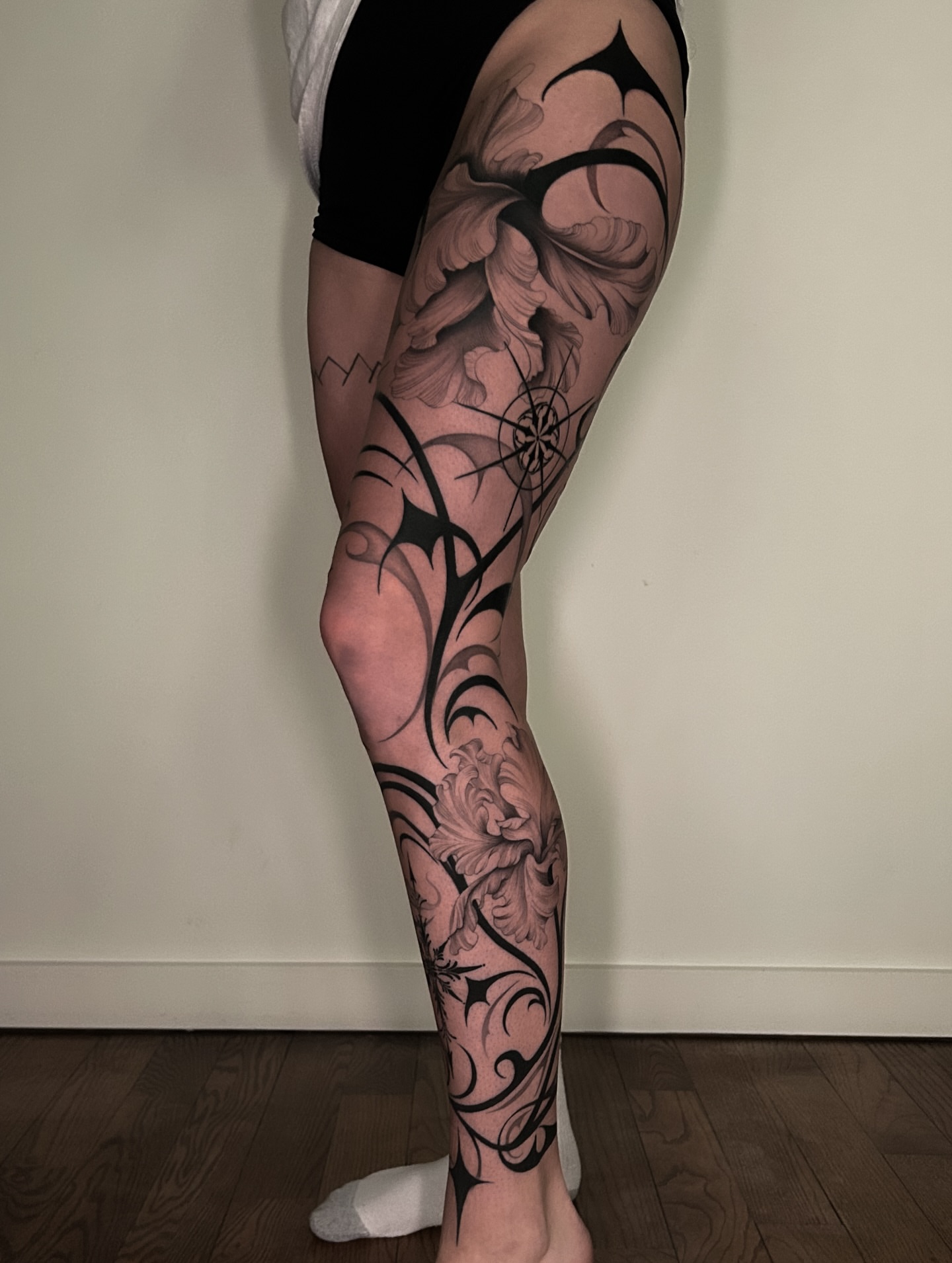 Floral design tribal tattoo on the calf by Crystal Thorns