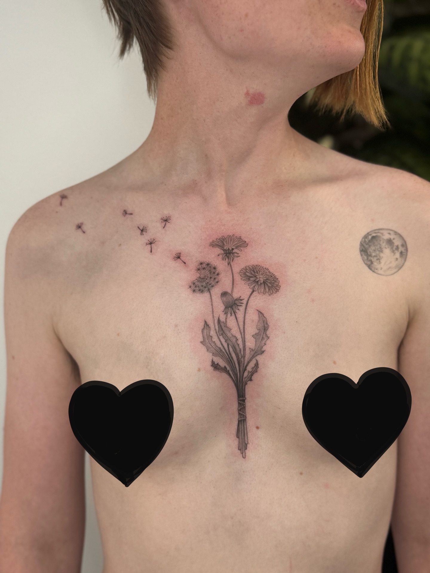 Dandelion bouquet black and grey tattoo on the chest by Lea Burkard, Berkeley, California