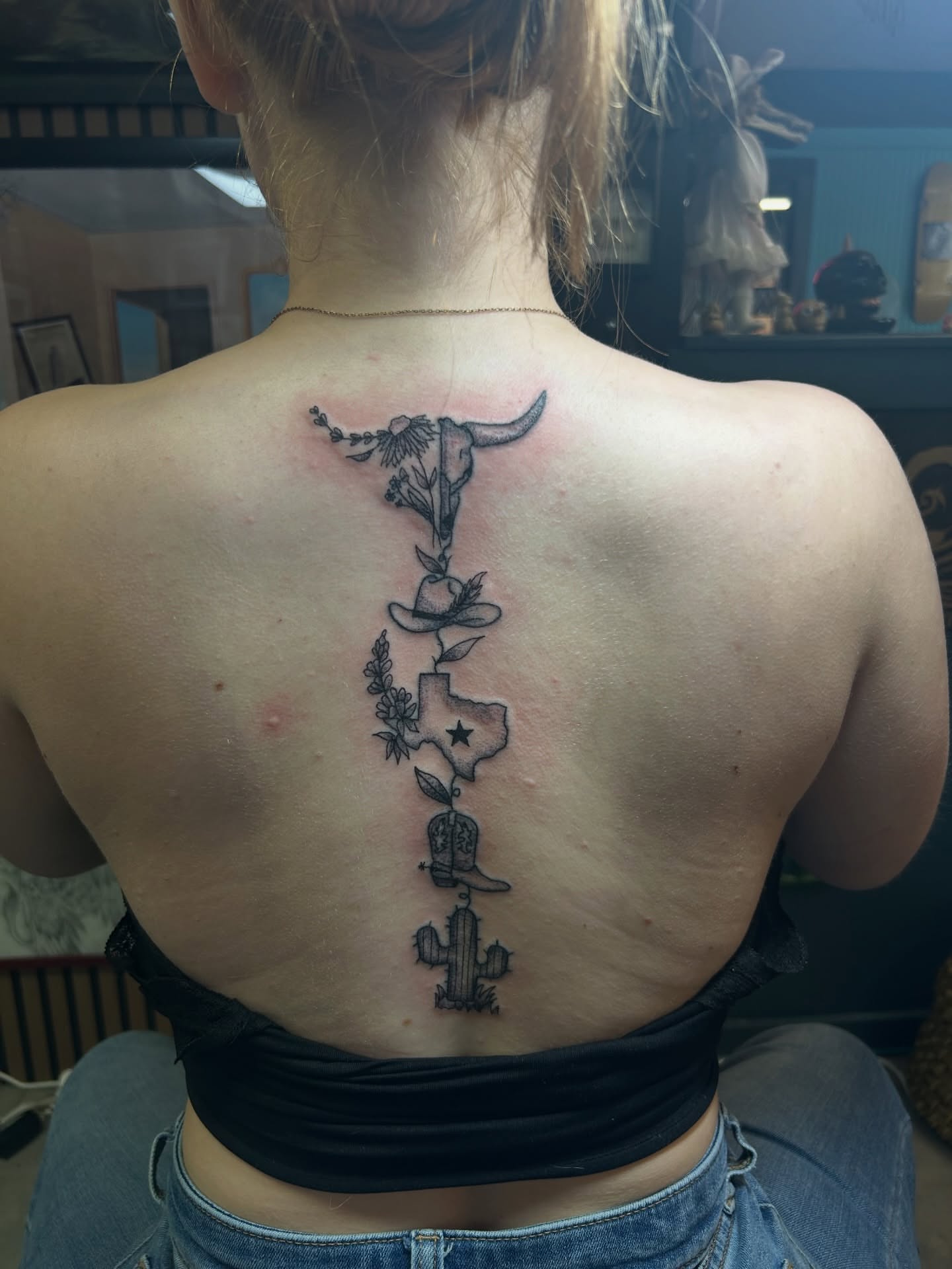 Western symbols black and grey tattoo on the back by Torrey, Austin, Texas