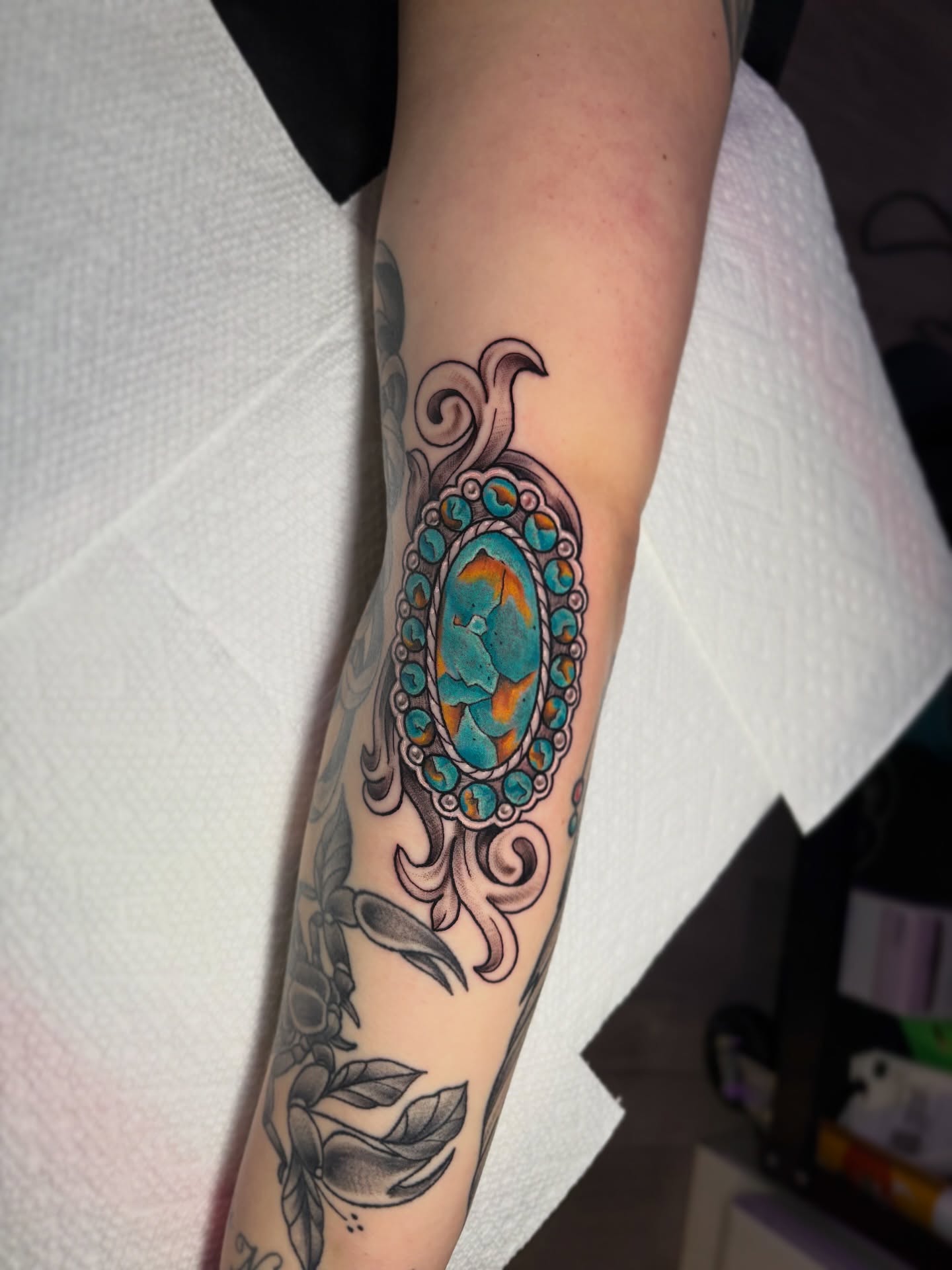 Gemstone and floral American traditional tattoo on the forearm by Bunny Noel