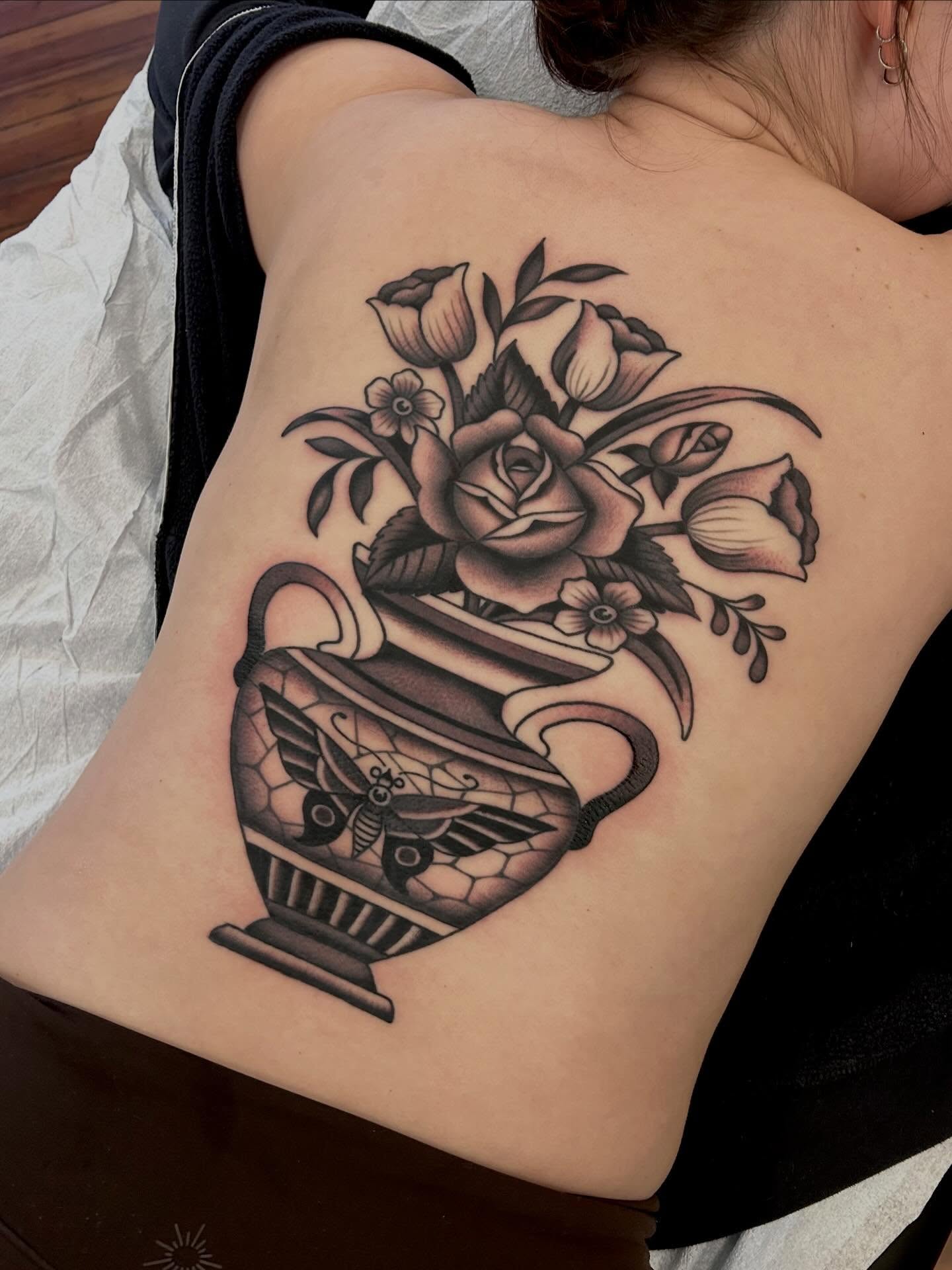 Vase with flowers black and grey tattoo on the back by Christian Lasyone