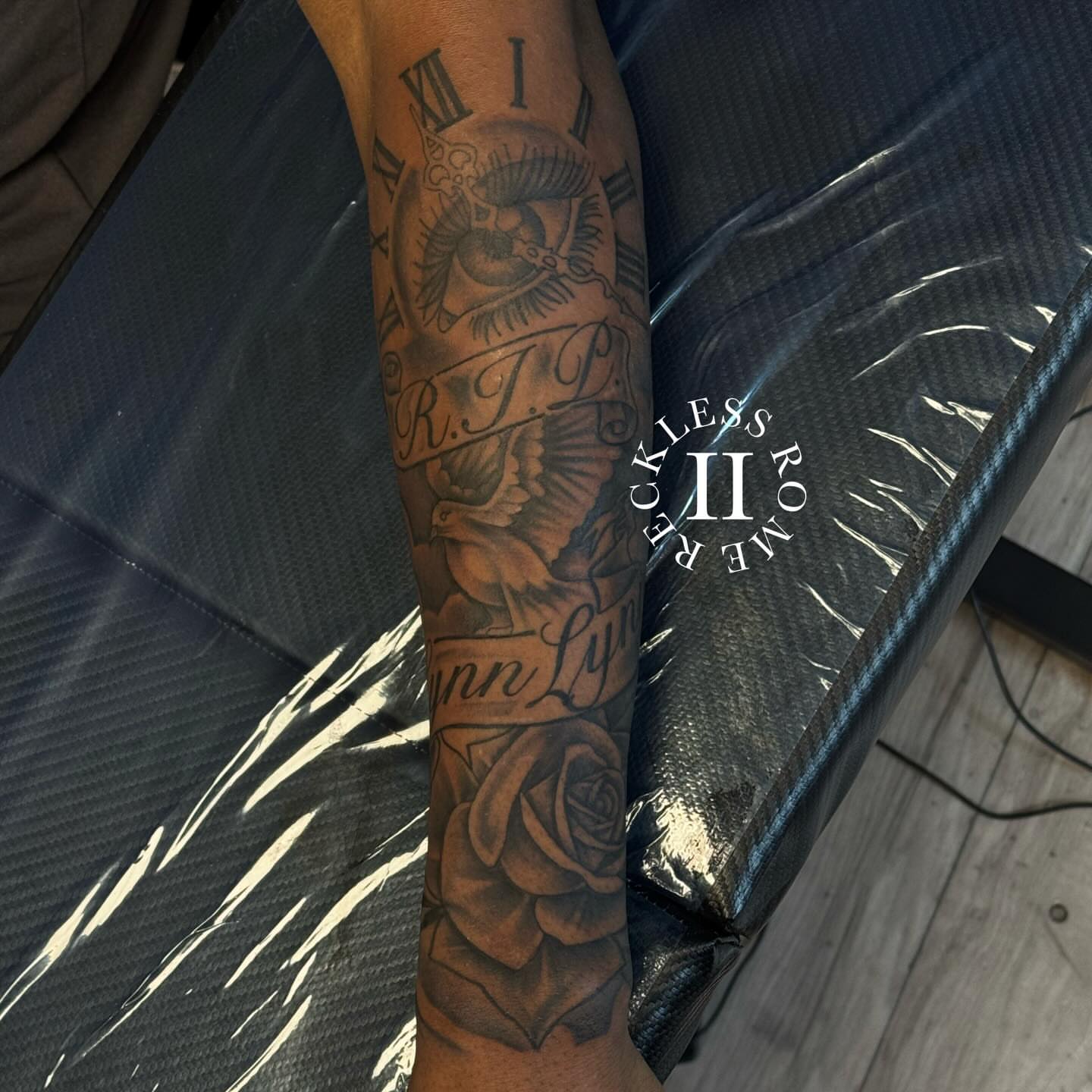 Rose and dove realism tattoo on the forearm by Rome