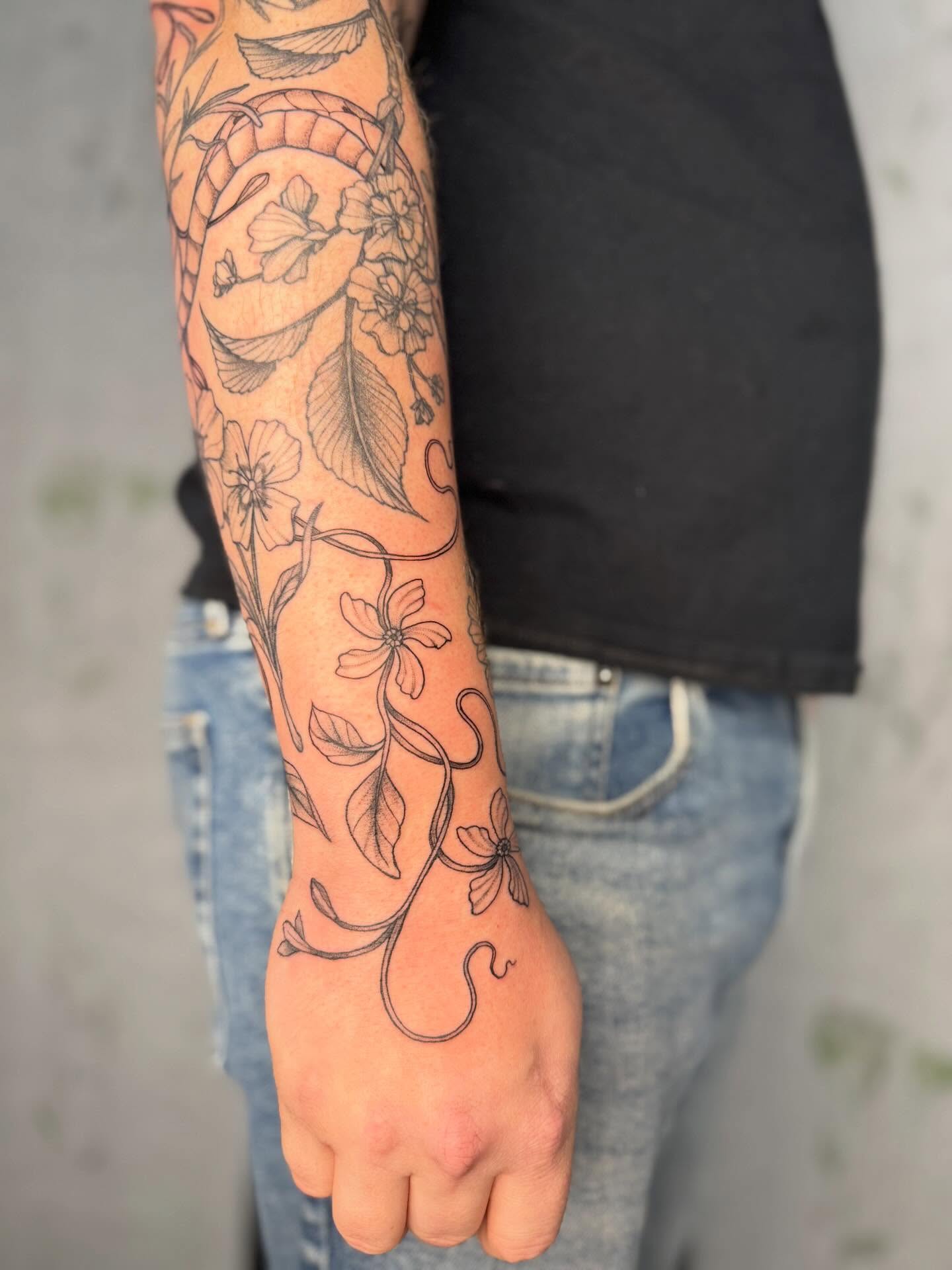 Floral vine black and grey tattoo on the forearm by Noelle Adrienne Tattoos