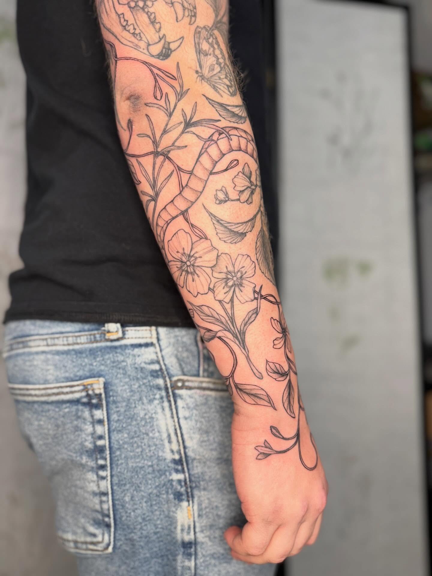 Snake and flowers American traditional tattoo on the forearm by Noelle Adrienne Tattoos