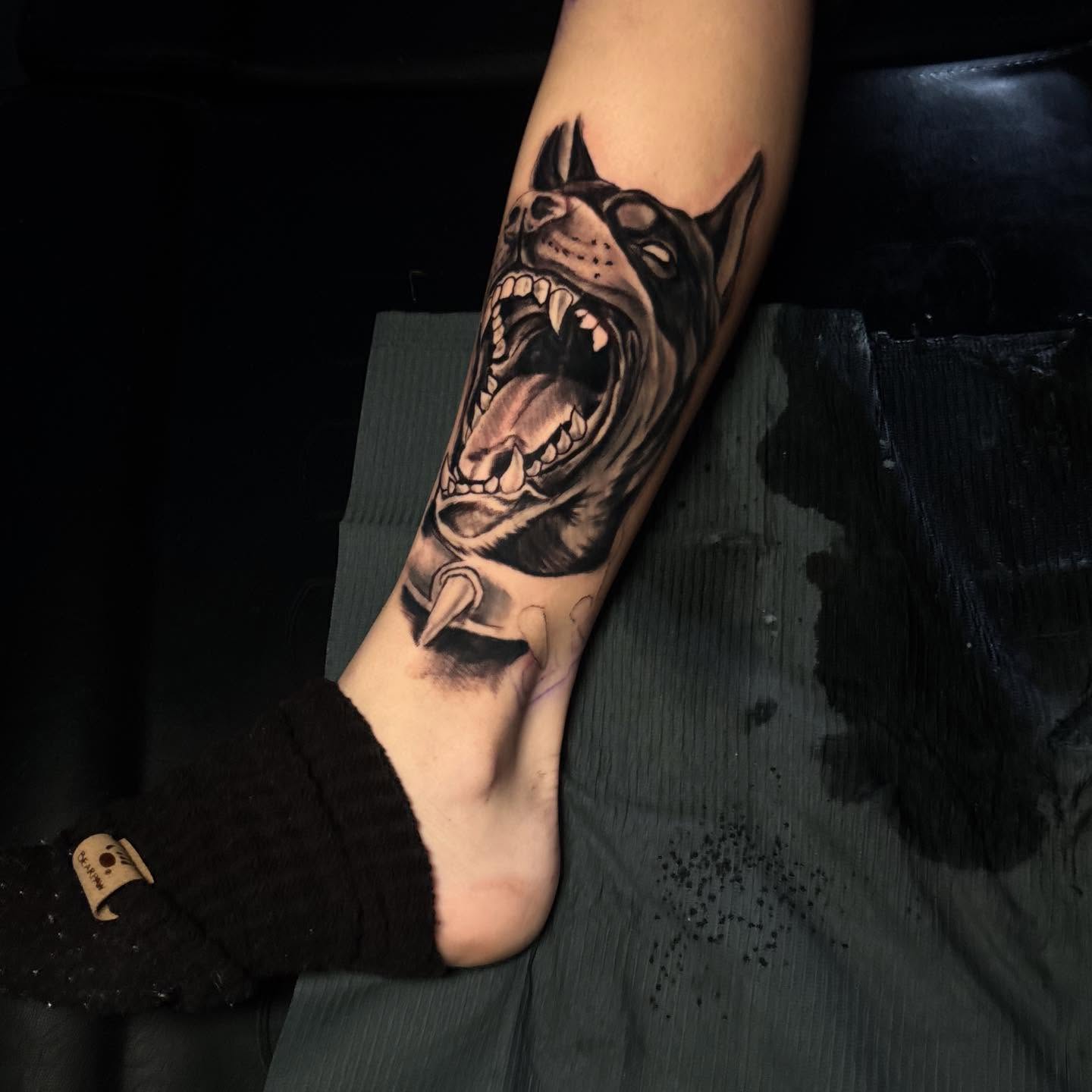 Roaring dog realism tattoo on the forearm by D. Davis