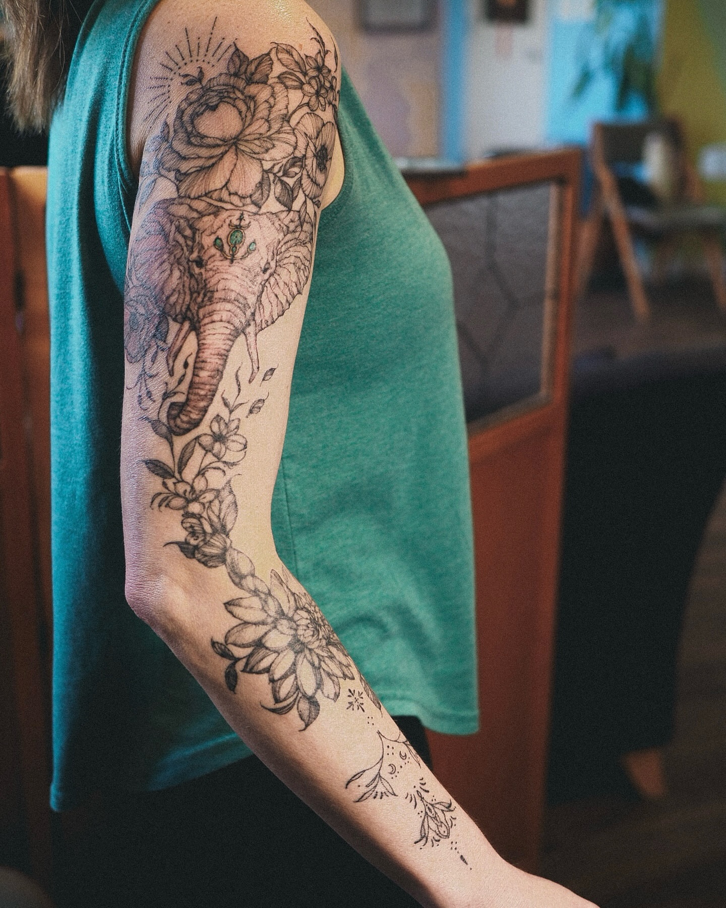 Elephant and floral black and grey tattoo on the forearm by Inks by Nastia
