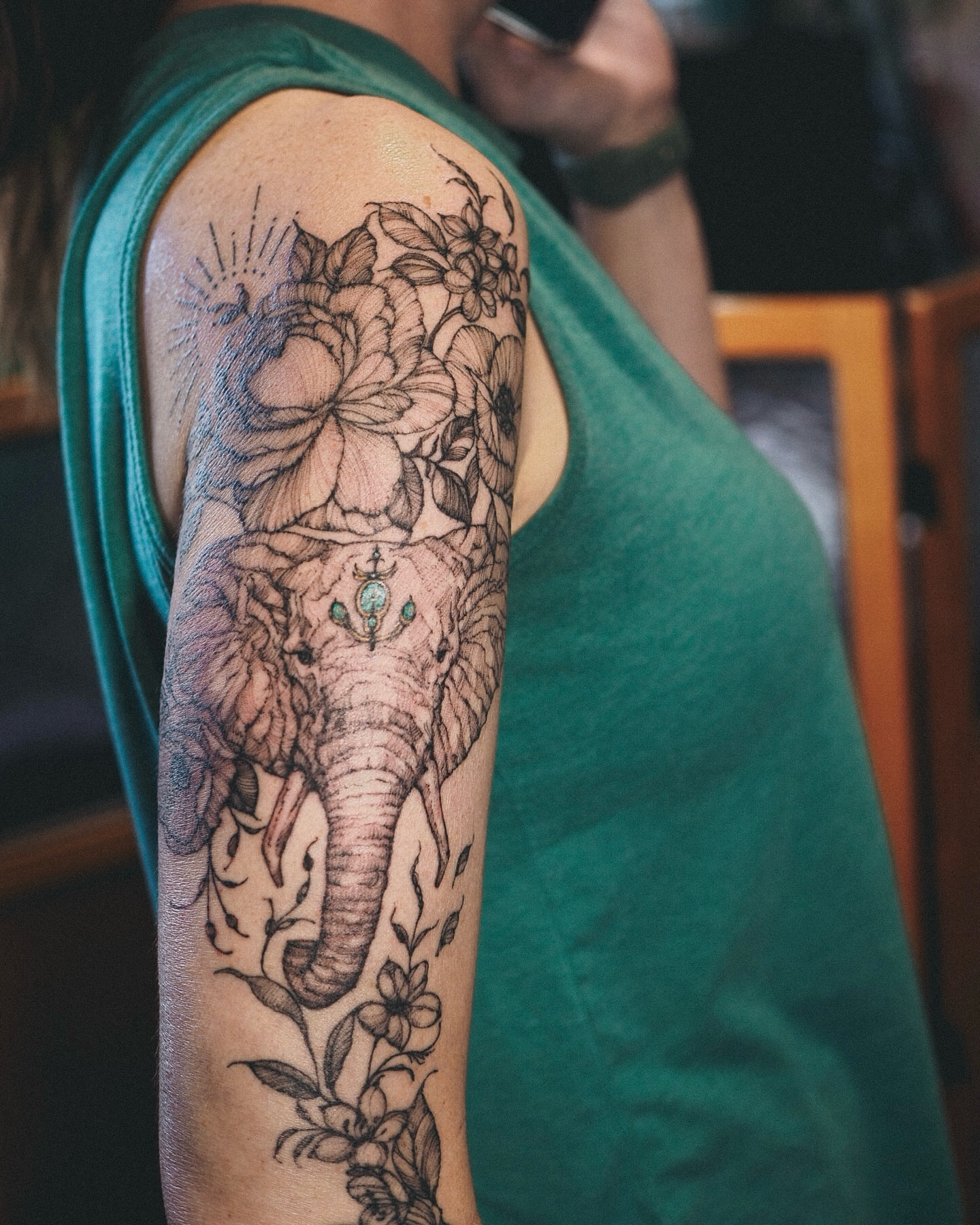 Elephant and floral realism tattoo on the upper arm by Inks by Nastia