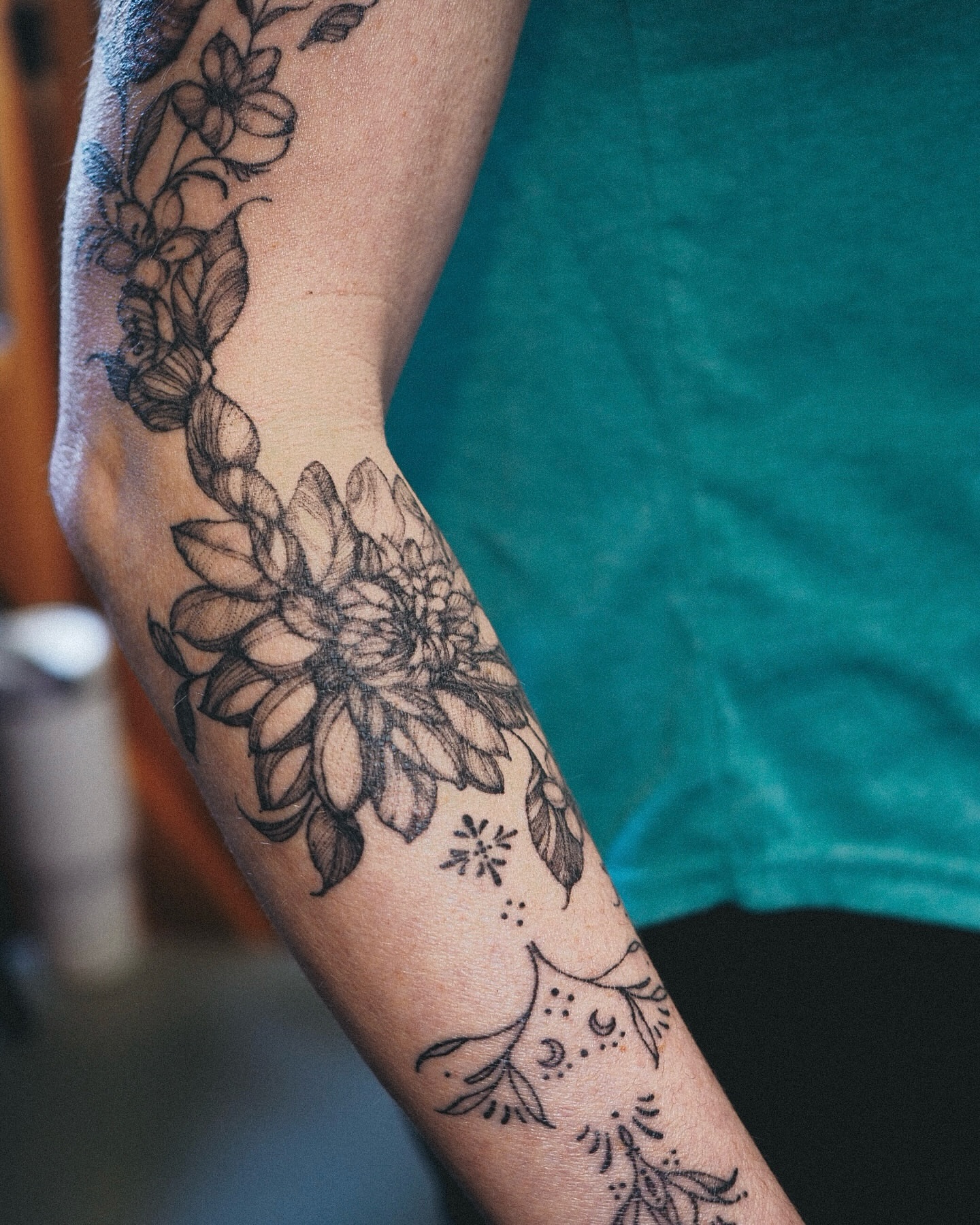 Floral design black and grey tattoo on the forearm by Inks by Nastia