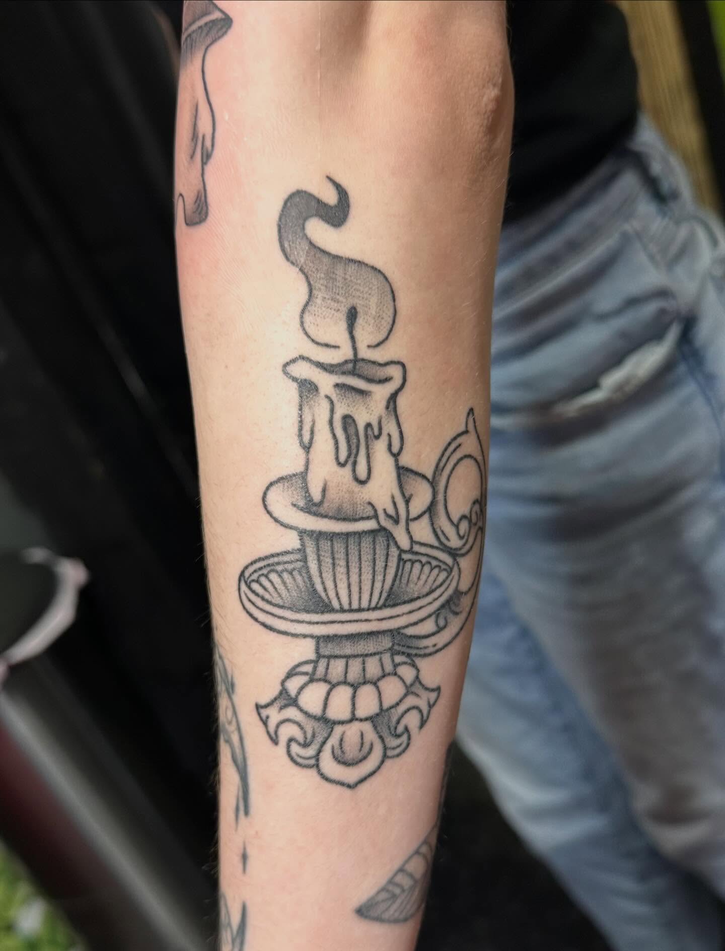 Candle black and grey tattoo on the forearm by Tattoo artist