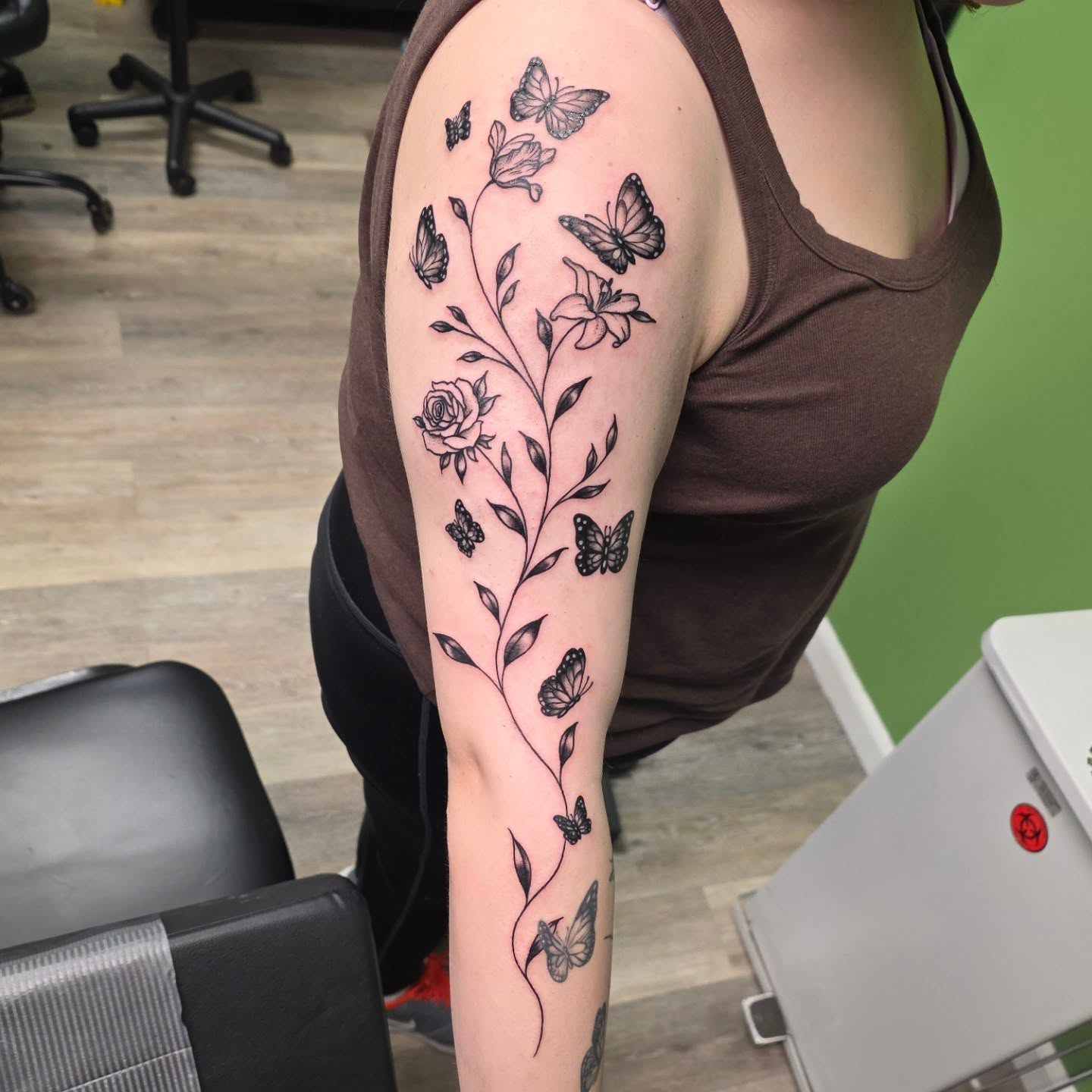 Floral and butterfly design black and grey tattoo on the forearm by 𝓚𝔂𝓻𝓪 𝓥𝓮𝓻𝓻𝔂