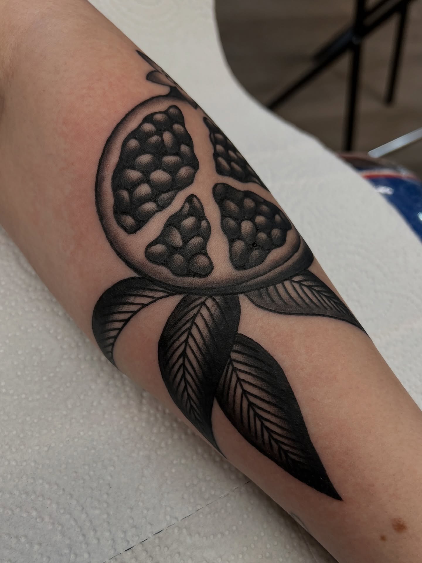 Granadilla black and grey tattoo on the forearm by Kelsey Lane