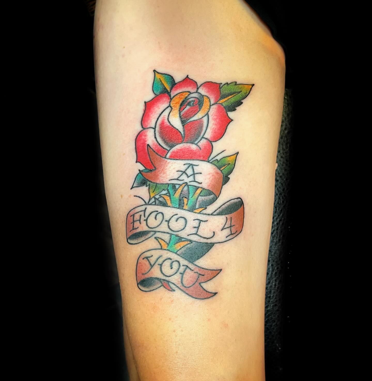 Rose with ribbon American traditional tattoo on the forearm by @sloanxkettering