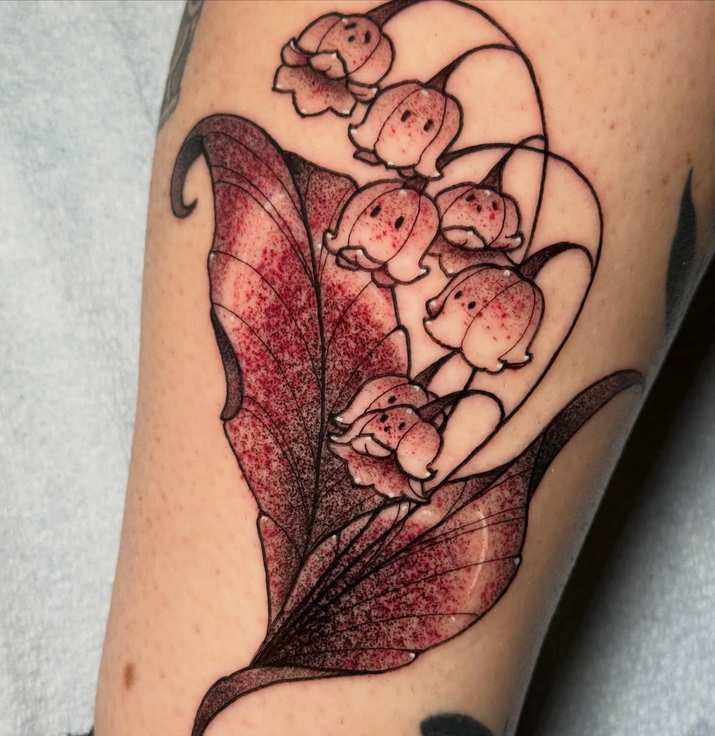 Lily of the valley dotwork tattoo on the forearm by Kayla Warren