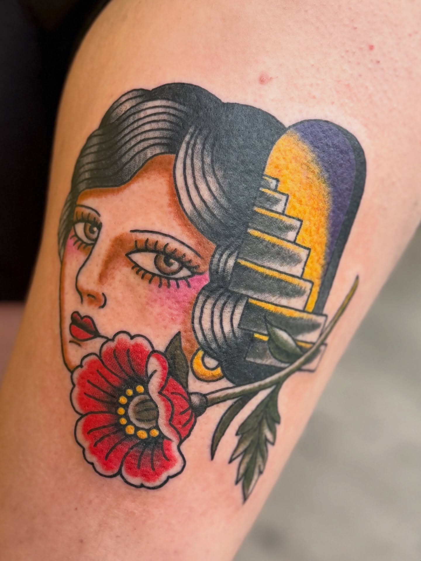 Woman with flower American traditional tattoo on the thigh by Devin Derbes