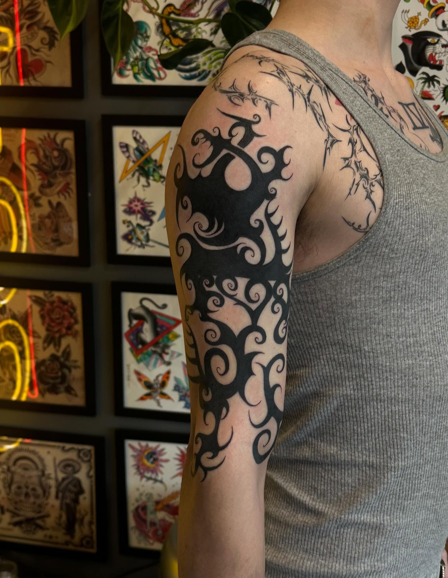 Tribal swirls tribal tattoo on the upper arm by Kerri Colello Sittenauer