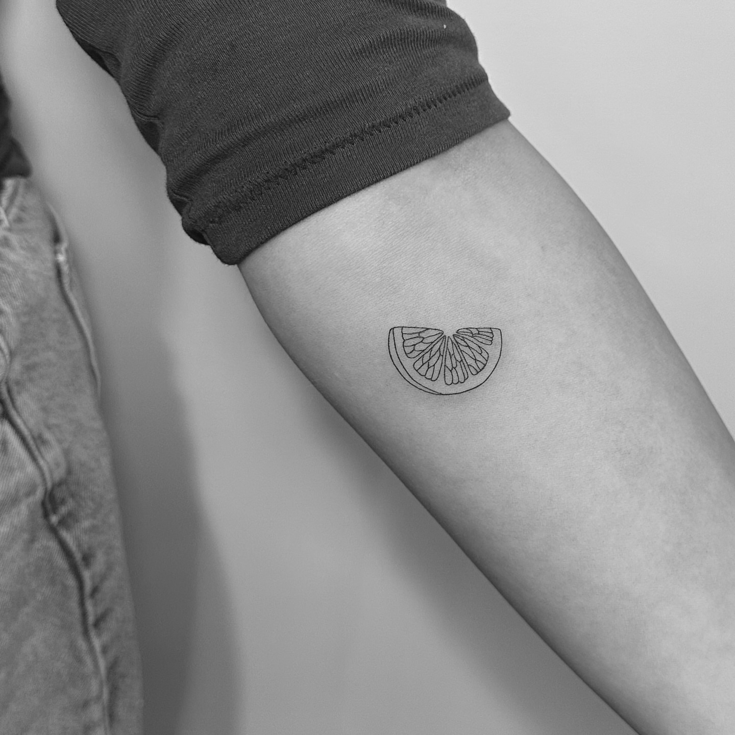 Slice of citrus fruit minimalist tattoo on the forearm by Jessica, Cheektowaga, New York