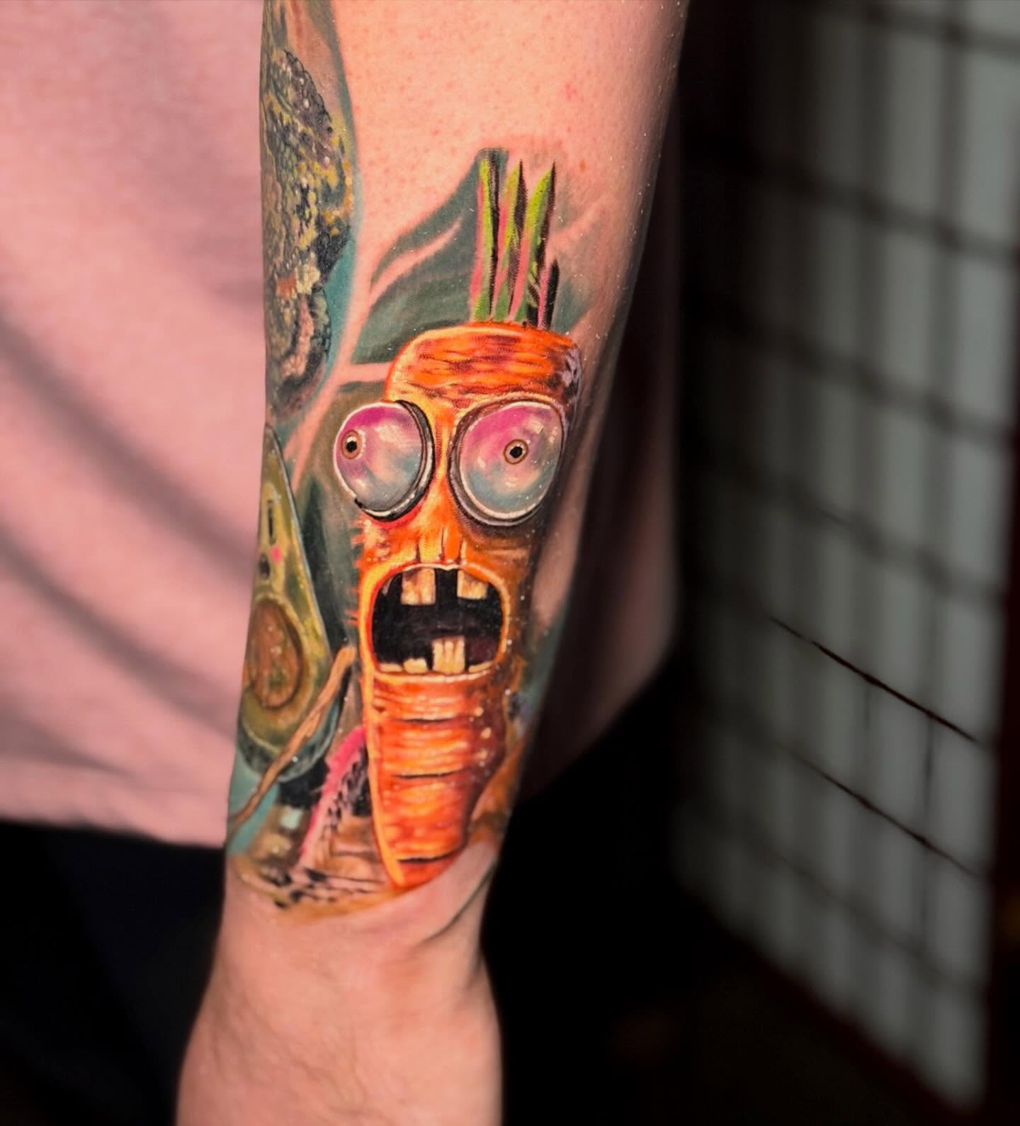 Alien head realism tattoo on the forearm by Johnny Scillieri