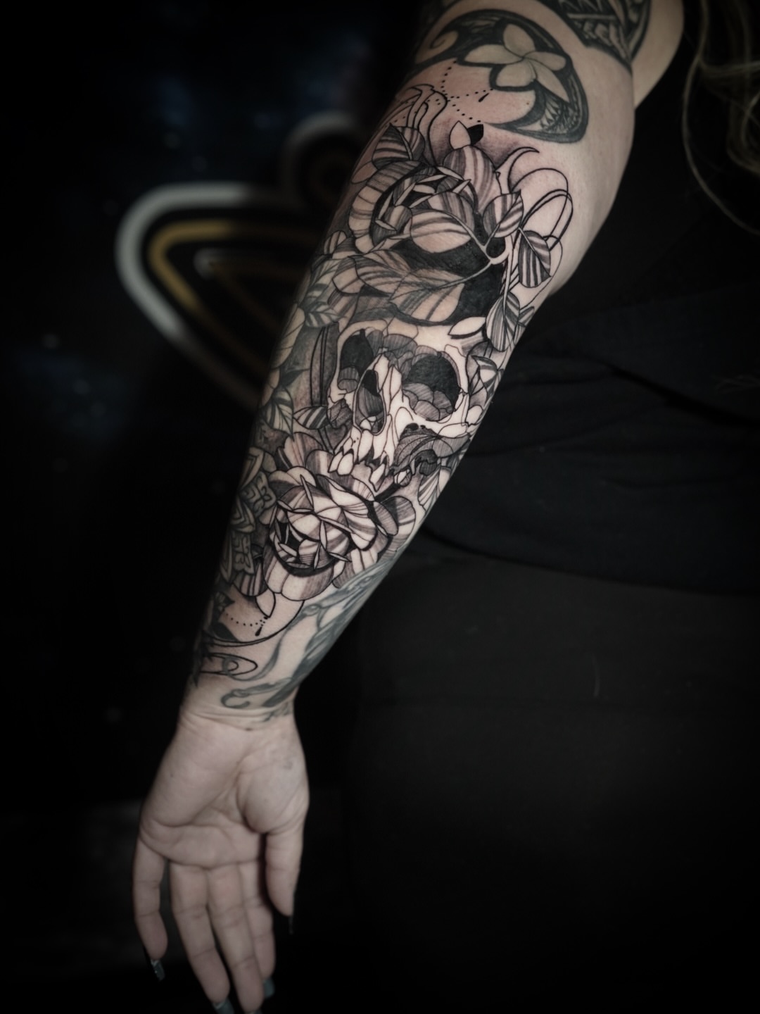 Skull and lotus geometric tattoo on the forearm by Niko Hosk Cataldo