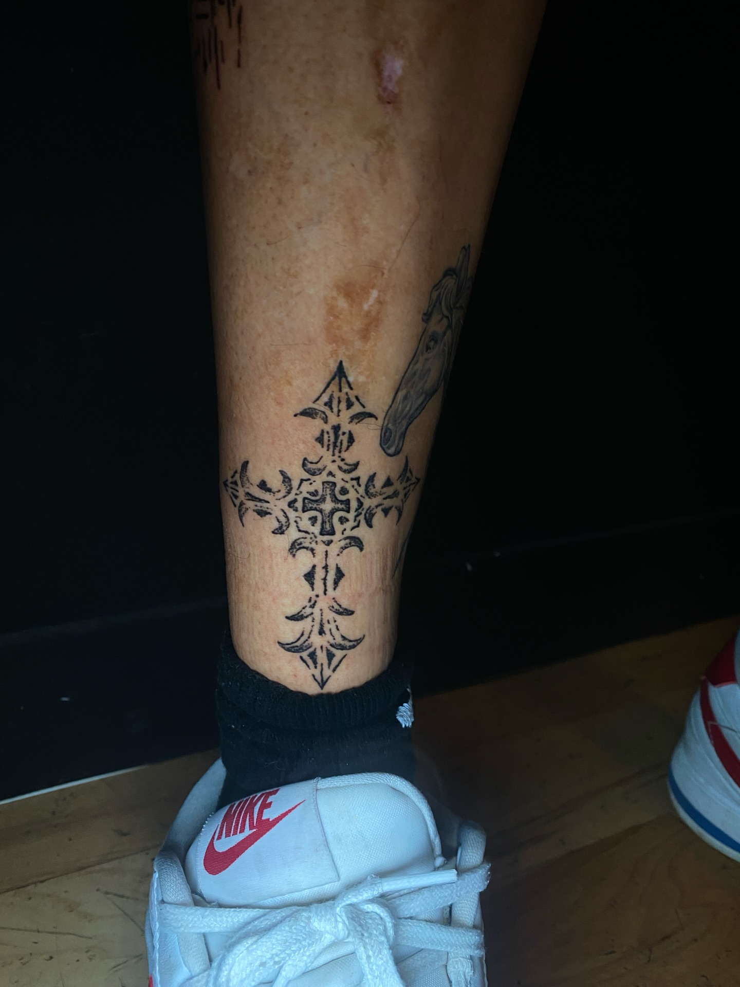 Cross black and grey tattoo on the calf by Cherry Jane 🍒