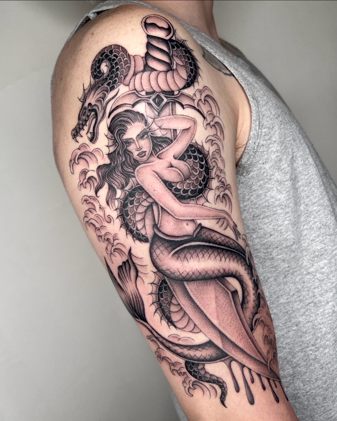 Mermaid American traditional tattoo on the upper arm by IVY